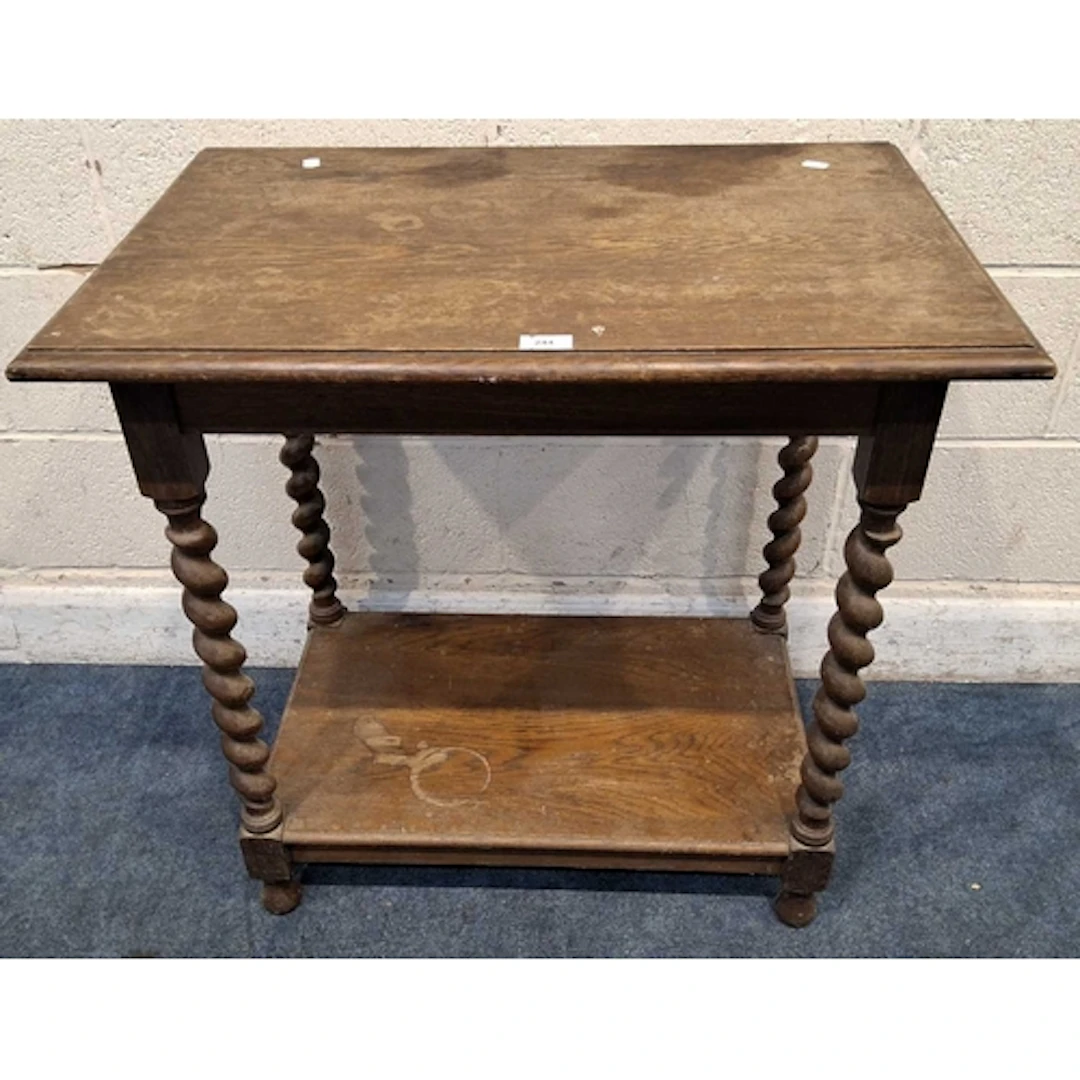 AN EARLY 20TH CENTURY OAK TABLE, raised on barley twist supp...