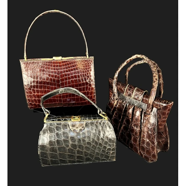 A vintage mid 20th century brown crocodile handbag with plea...