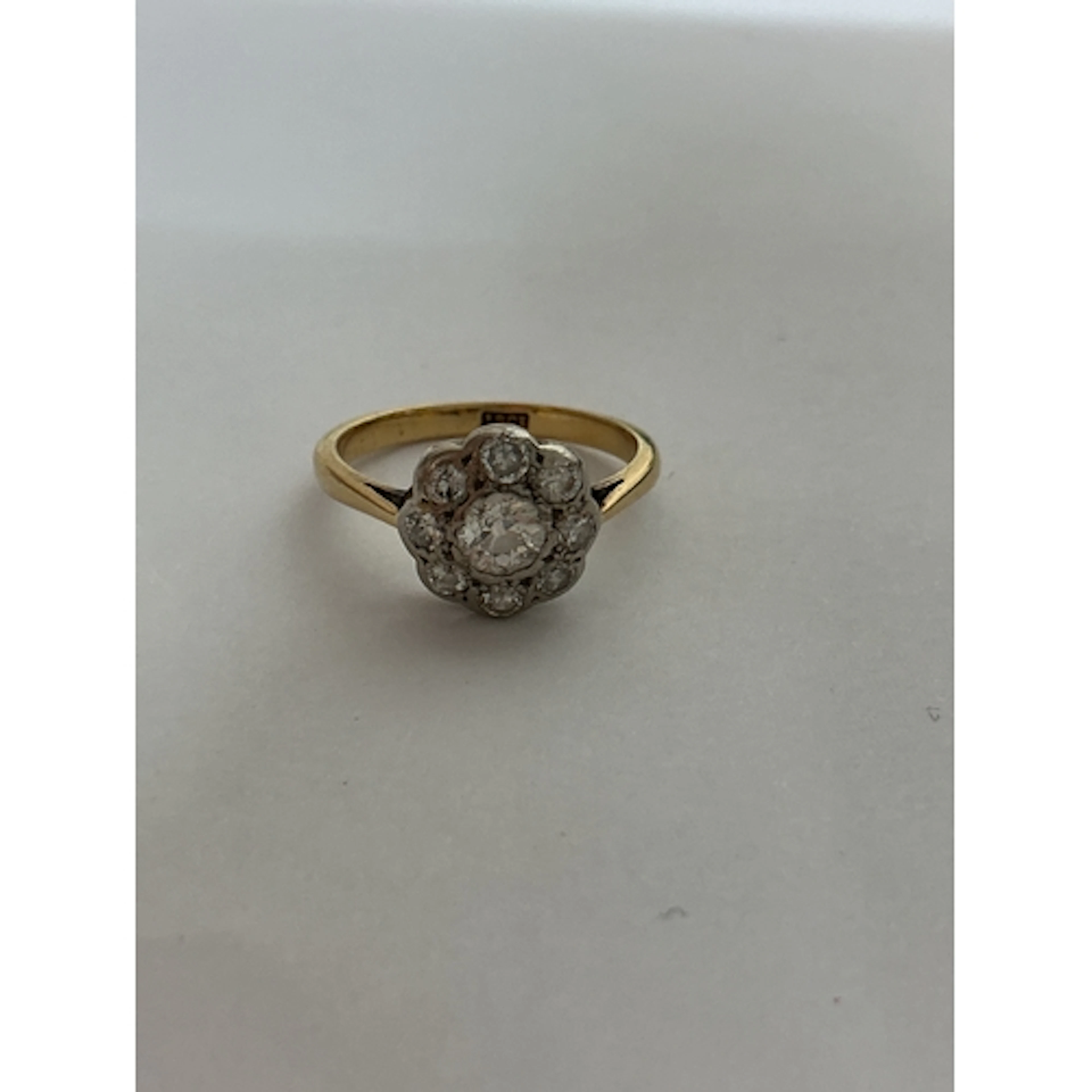 An 18ct gold and diamond ring with floral setting. Approx si...