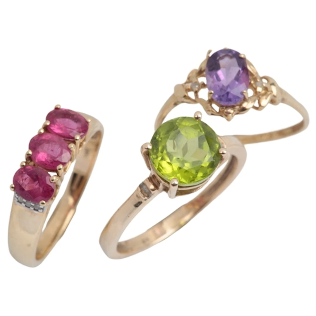 A recent 9ct gold and three stone pink tourmaline set ring, ...