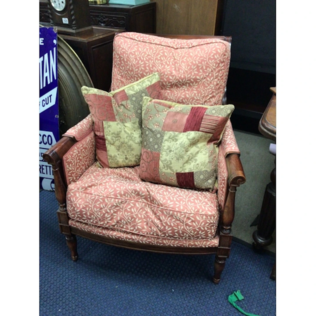 A Regency style arm chair with a patterned fabric and loose ...