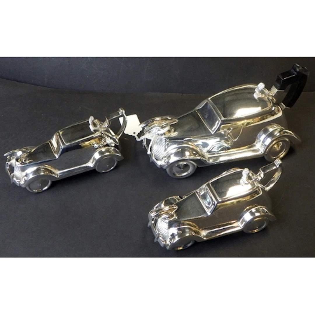 A plated 3pc tea set in the form of vintage cars
