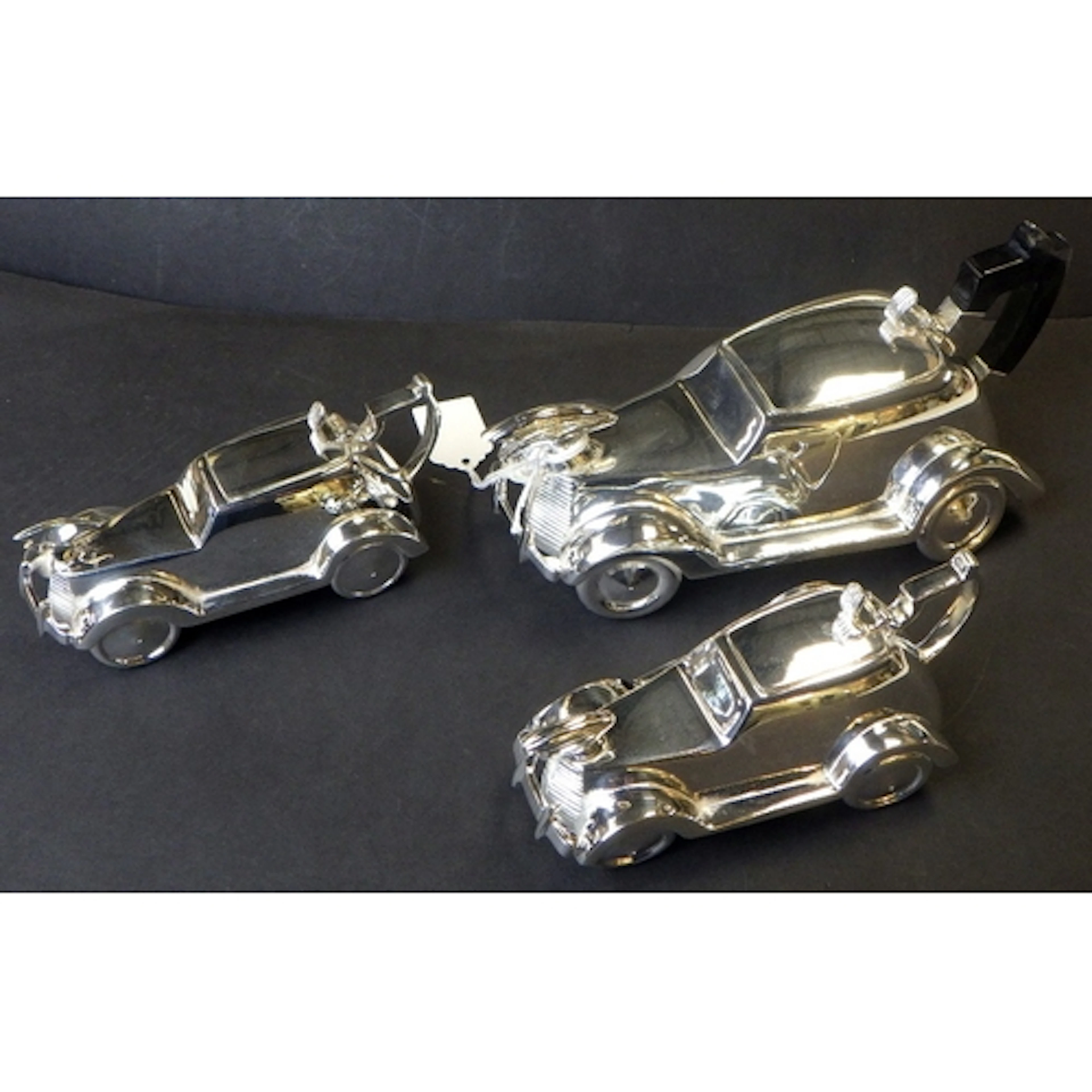 A plated 3pc tea set in the form of vintage cars