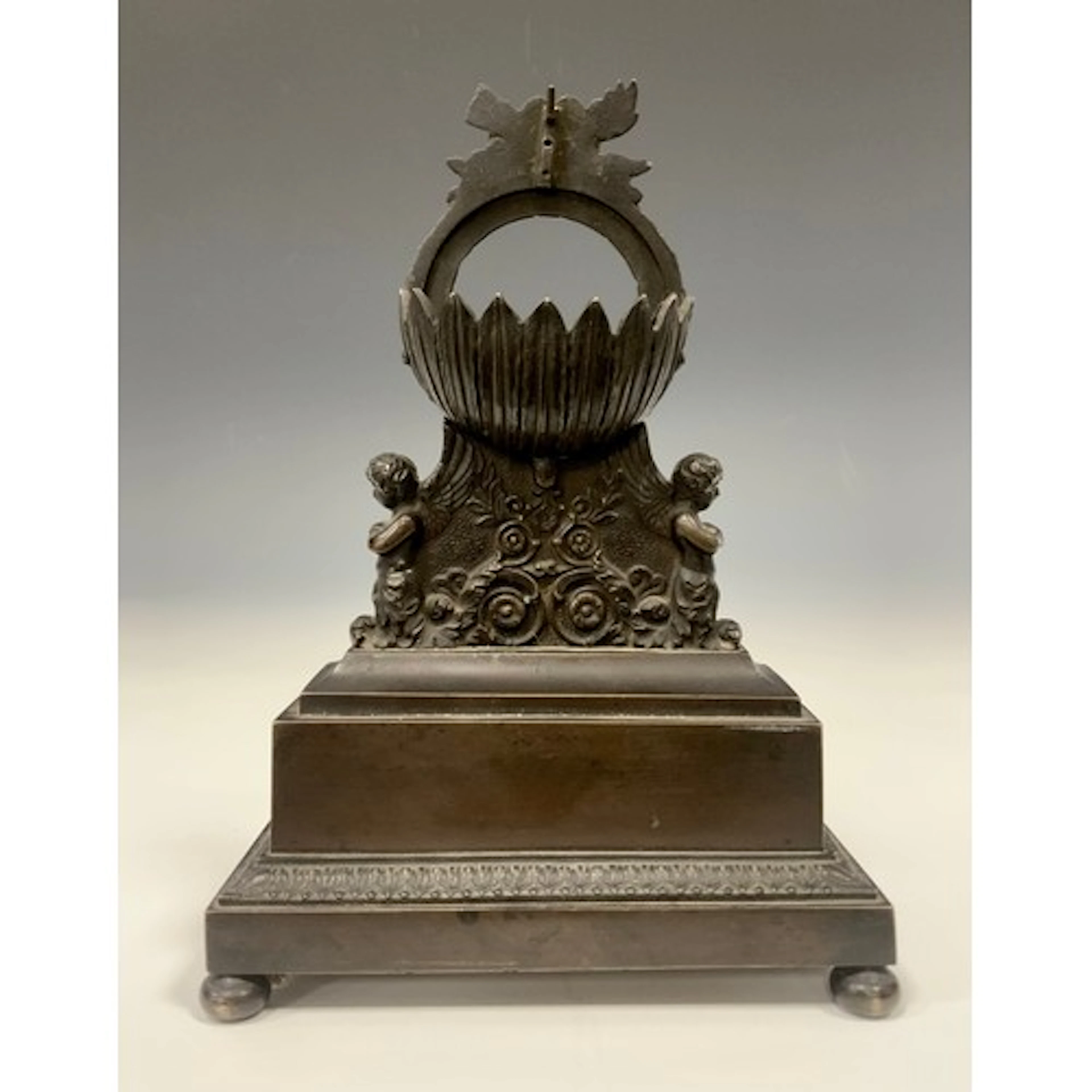 A Regency bronze pocket watch stand, the circular aperture c...