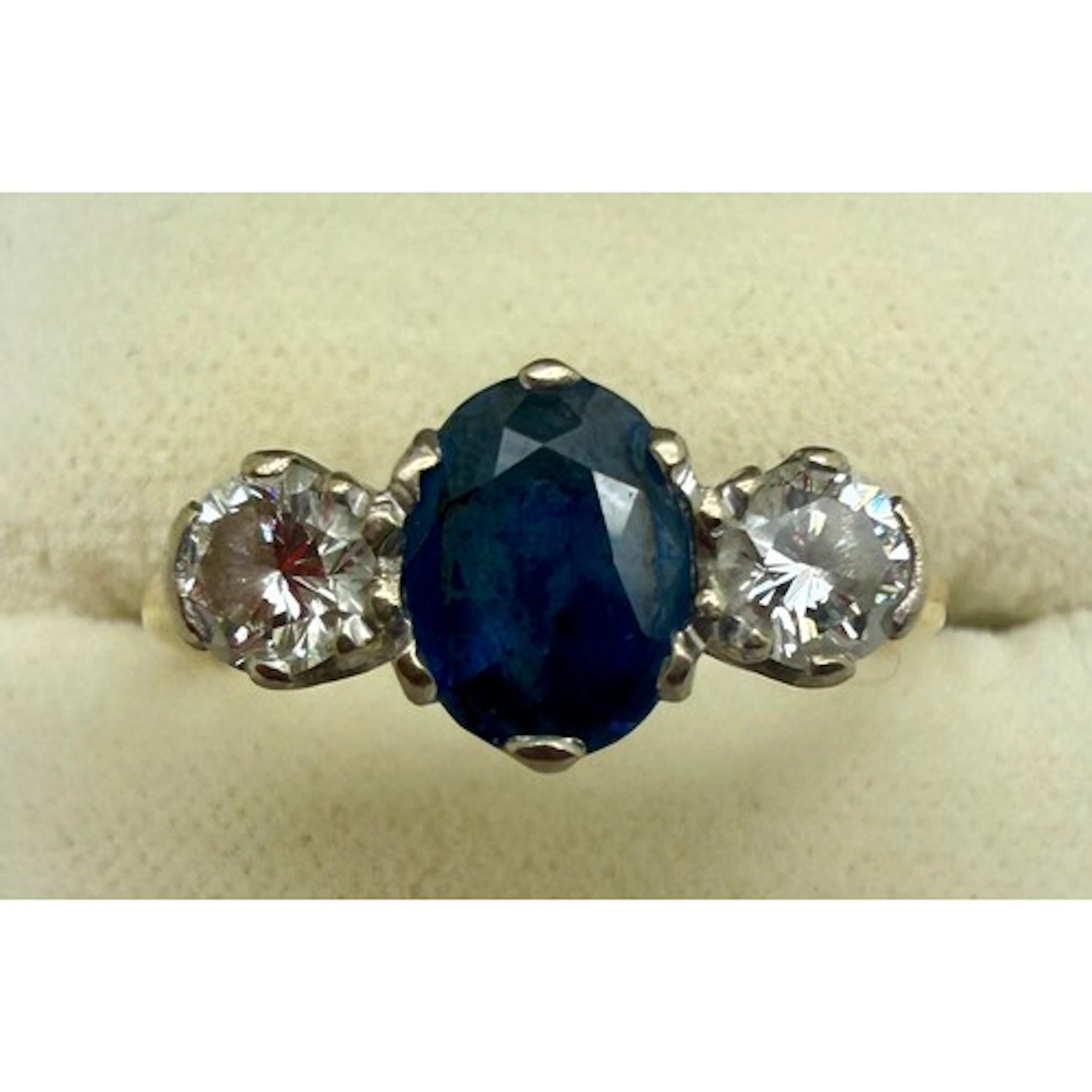 A three stone sapphire and diamond ring. Size Q. Weight 3.8g...