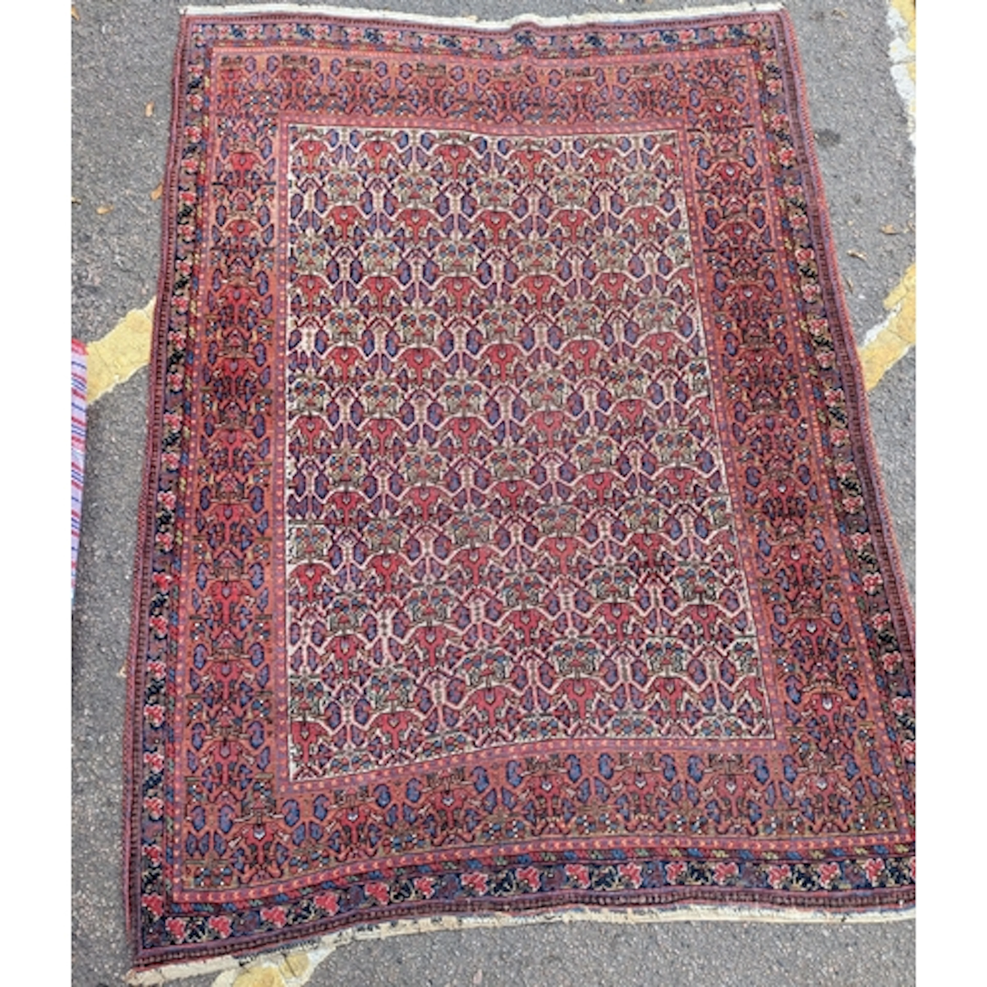 A hand knotted Bokhara rug, 173cm x 126cm, having geometric ...
