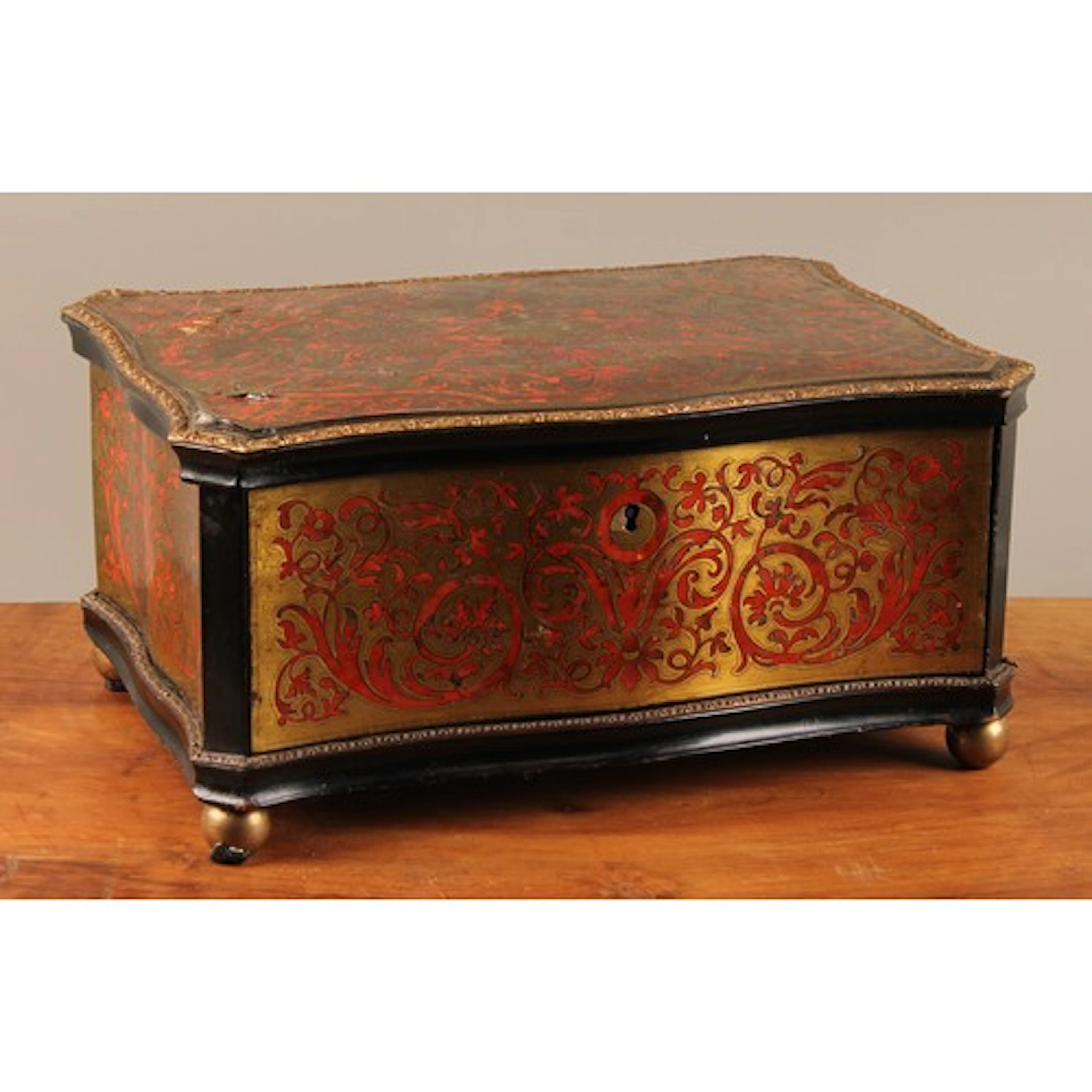 A 19th century boulle serpentine dressing table box, hinged ...