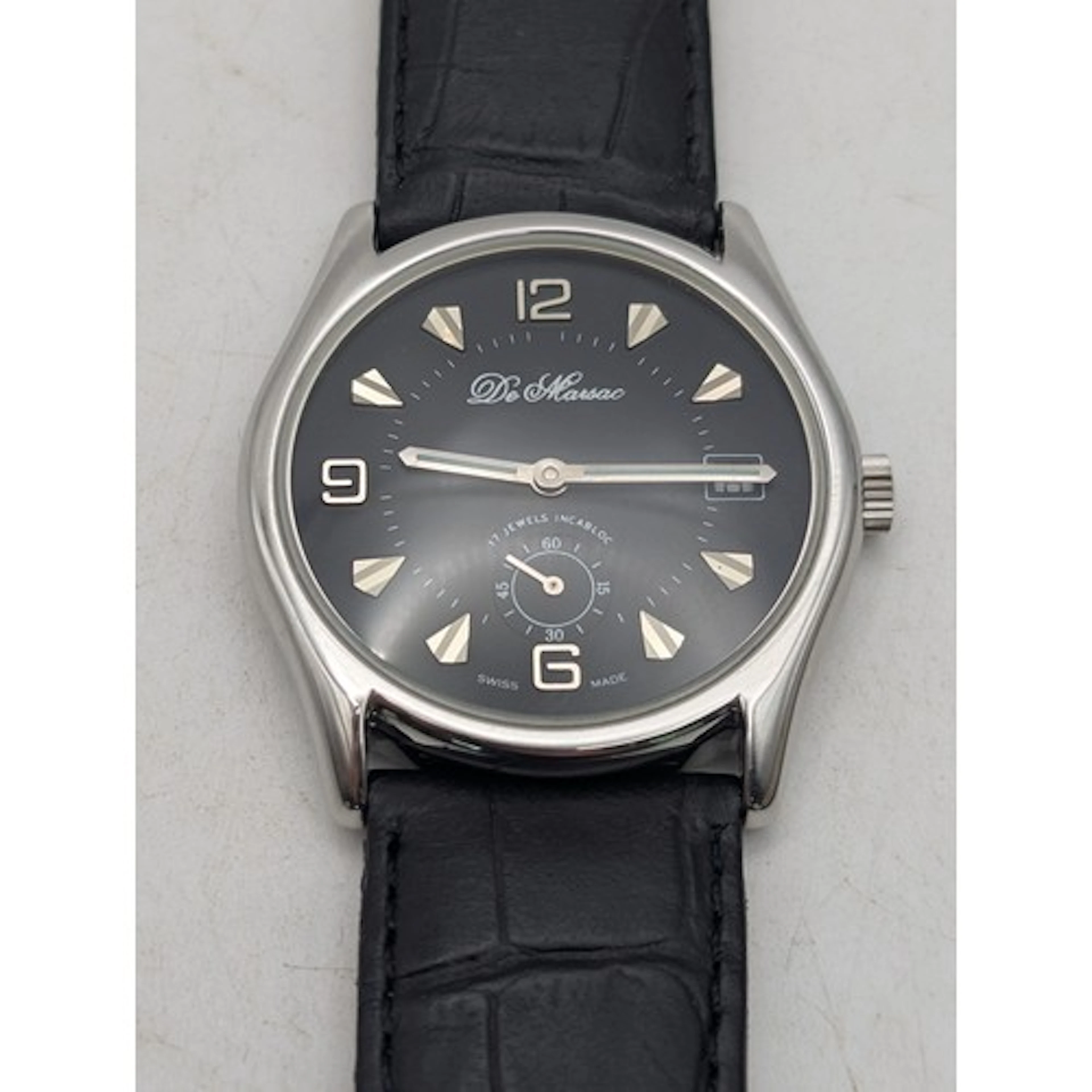 A gents stainless steel wristwatch, having black dial on bla...