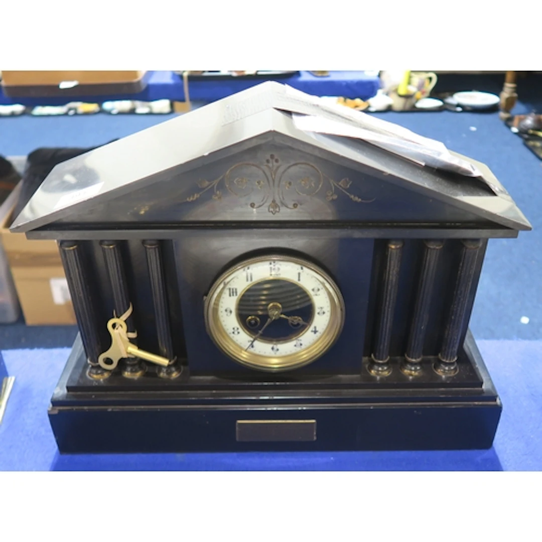 A slate mantle clock of classical form with six columns to t...