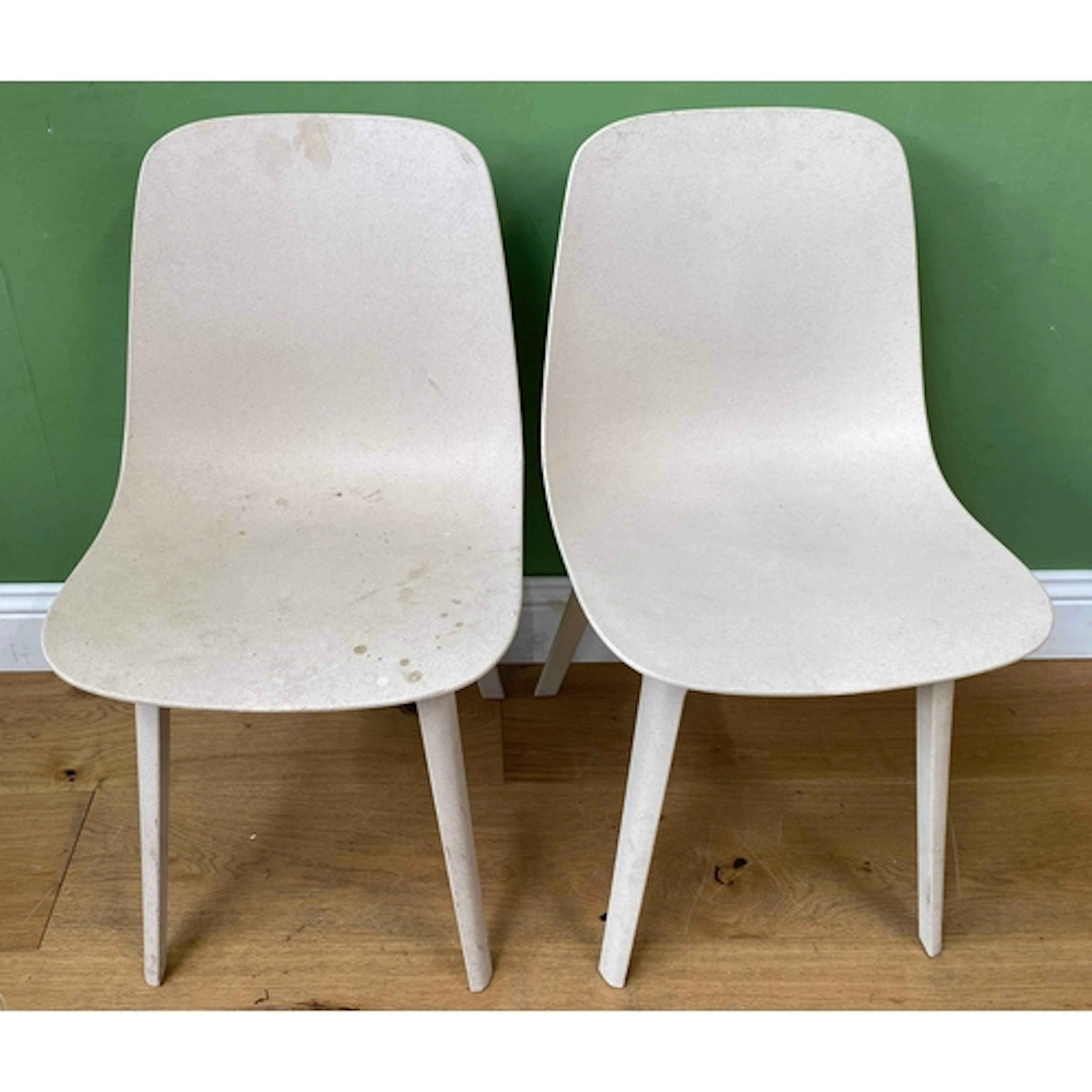 A pair of Ikea white chairs