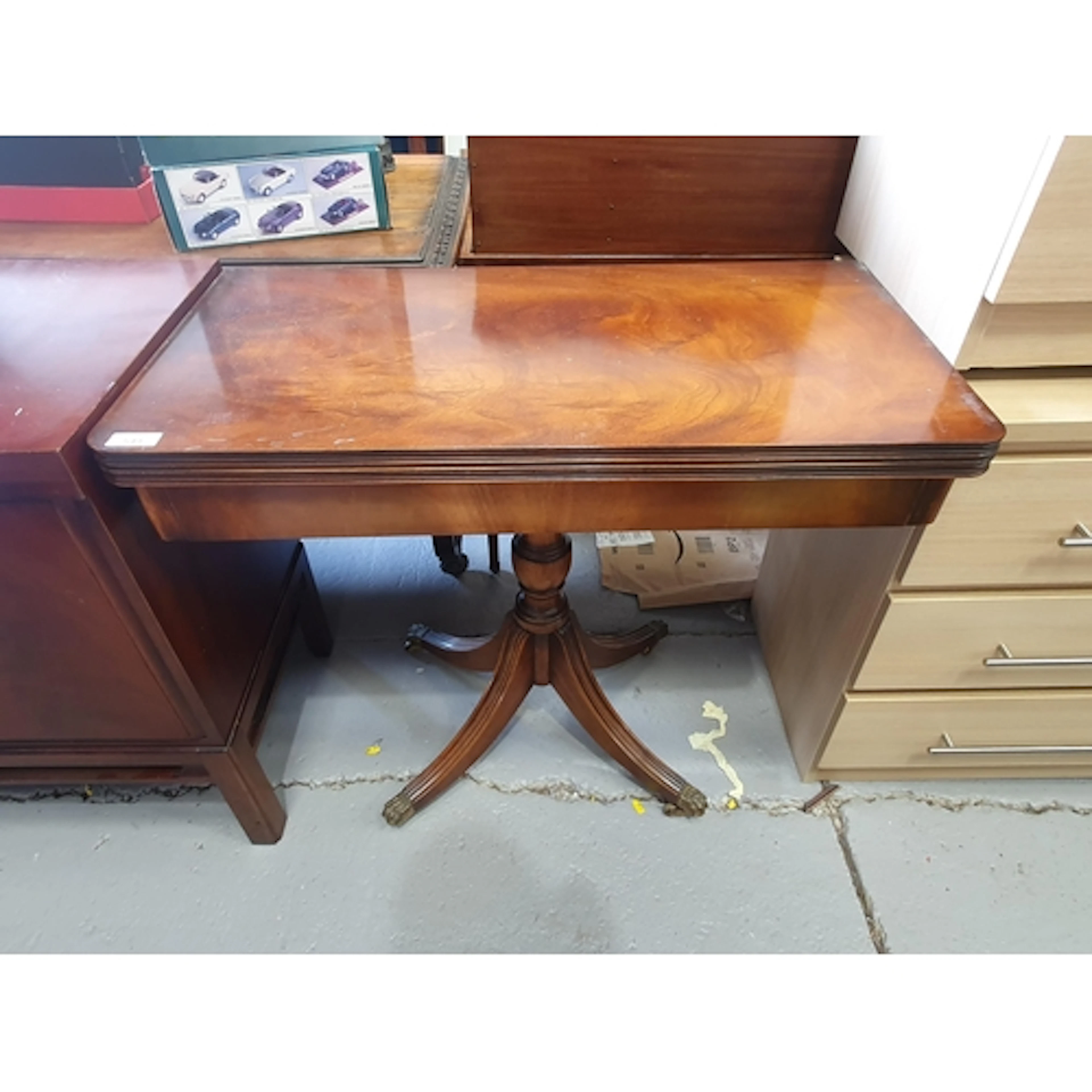 A mahogany fold over card Table raised on quadruple reeded s...