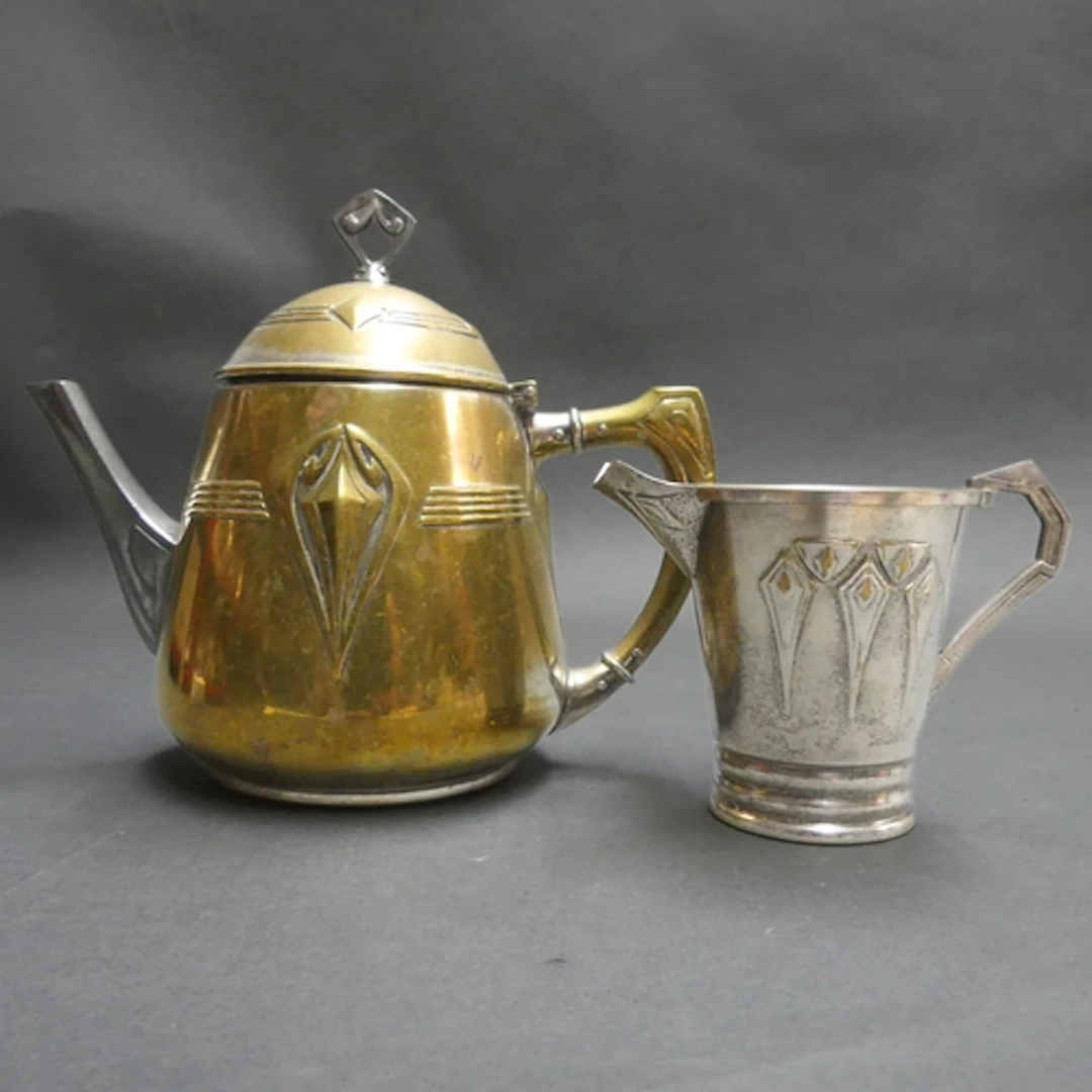 WMF - An Art Nouveau silver plated teapot and matching cream...