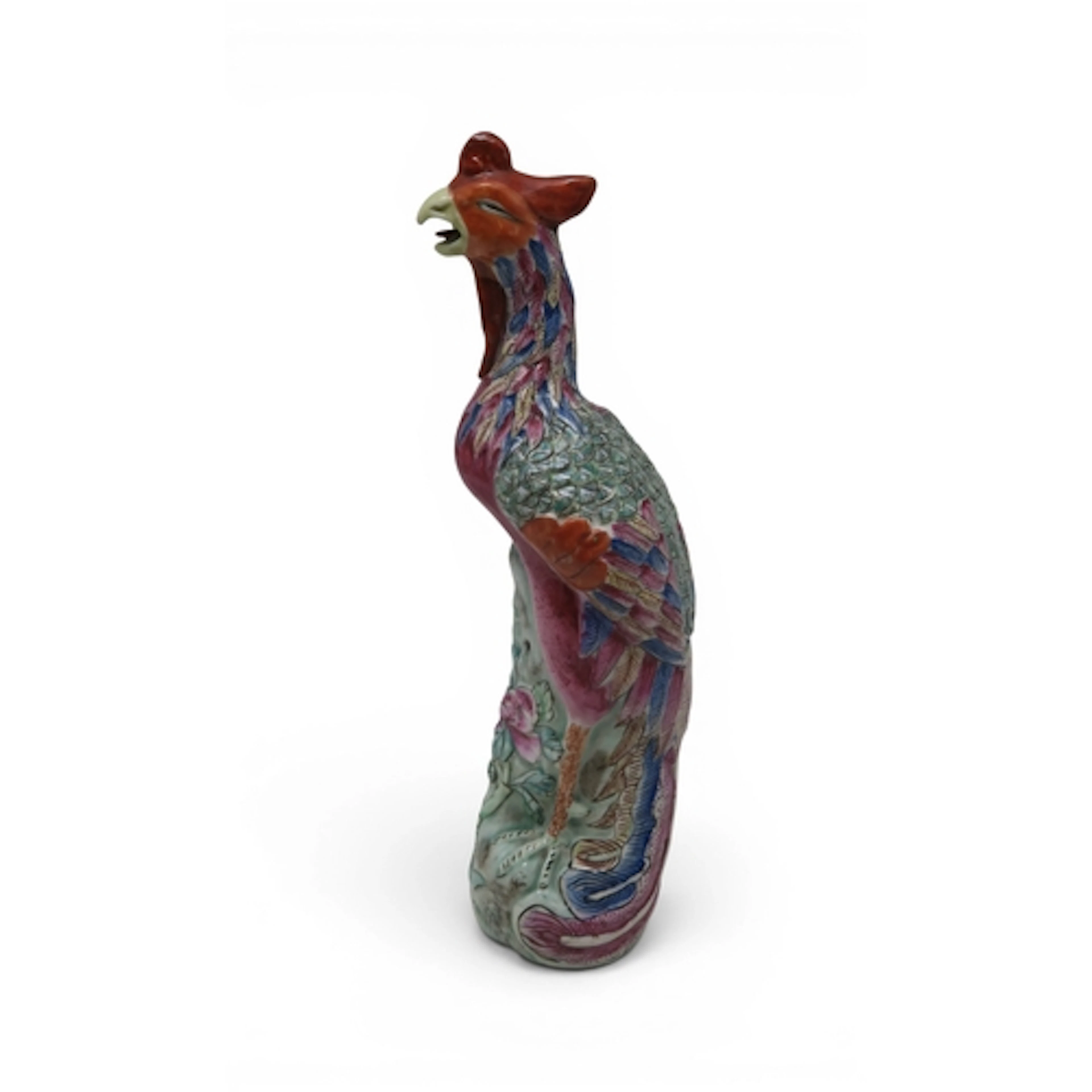 A Chinese Famille rose phoenix, modelled on a rocky outcrop,...