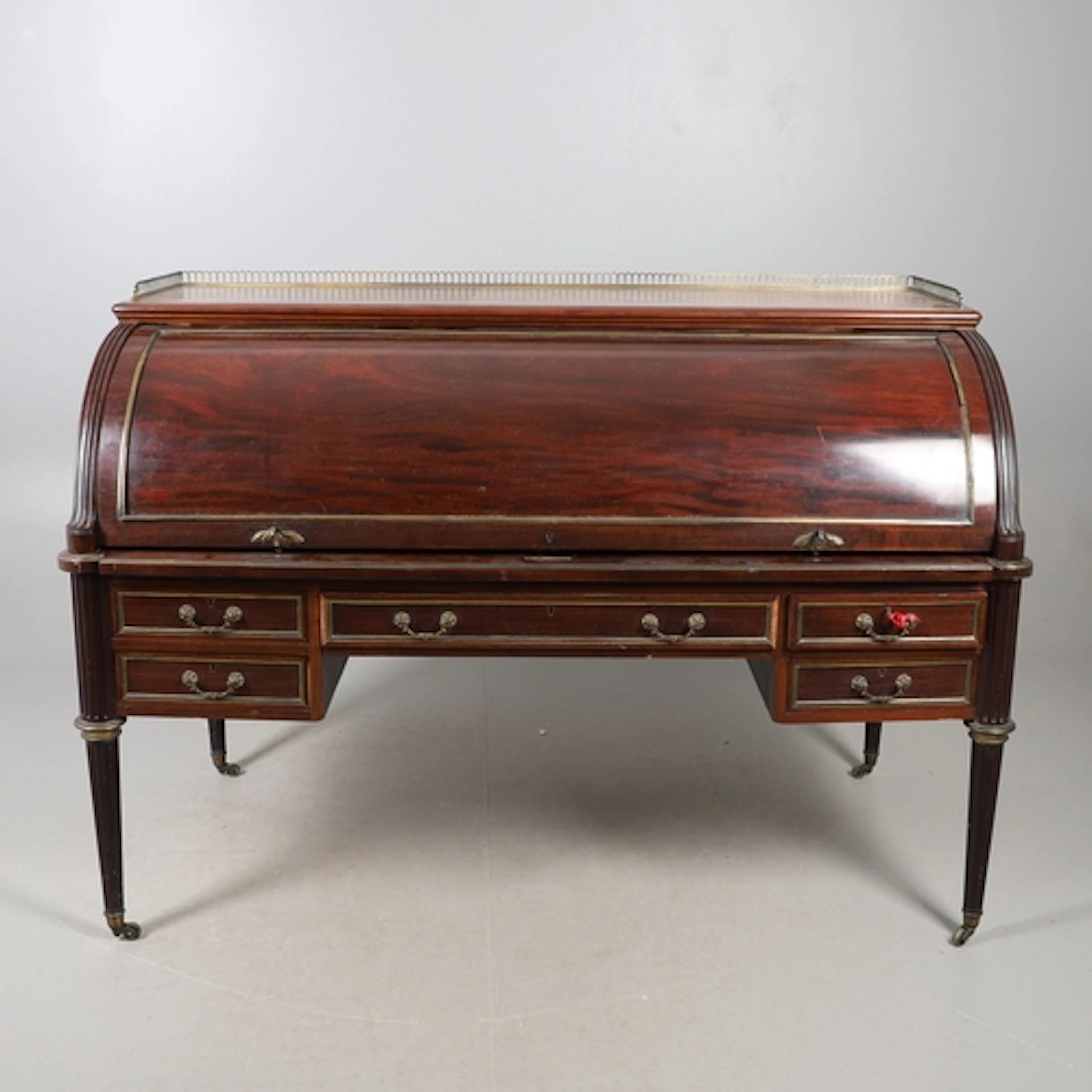A SUBSTANTIAL EDWARDIAN MAHOGANY CYLINDER DESK BY WILLIAM BE...