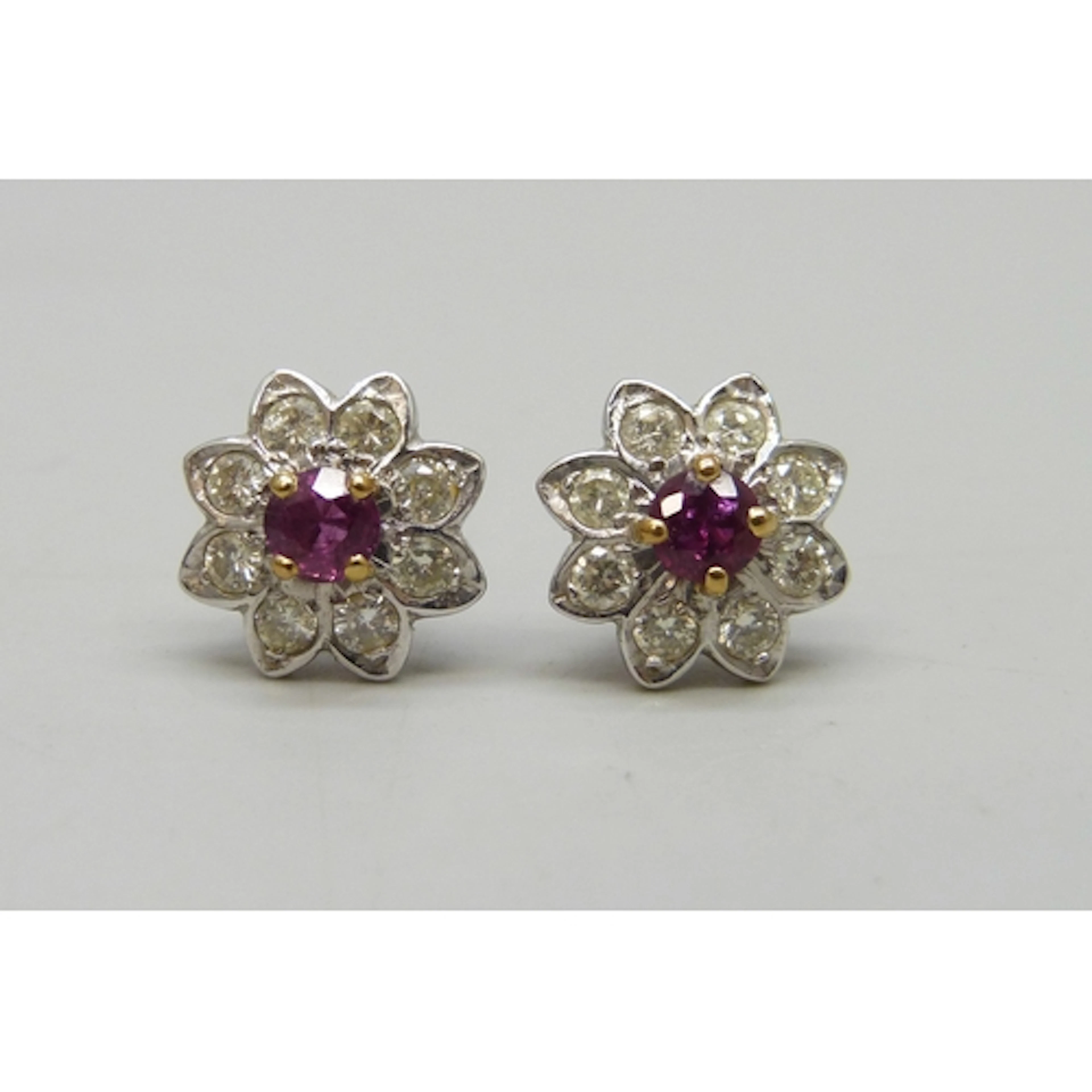A pair of white metal, ruby and diamond cluster earrings, 3....