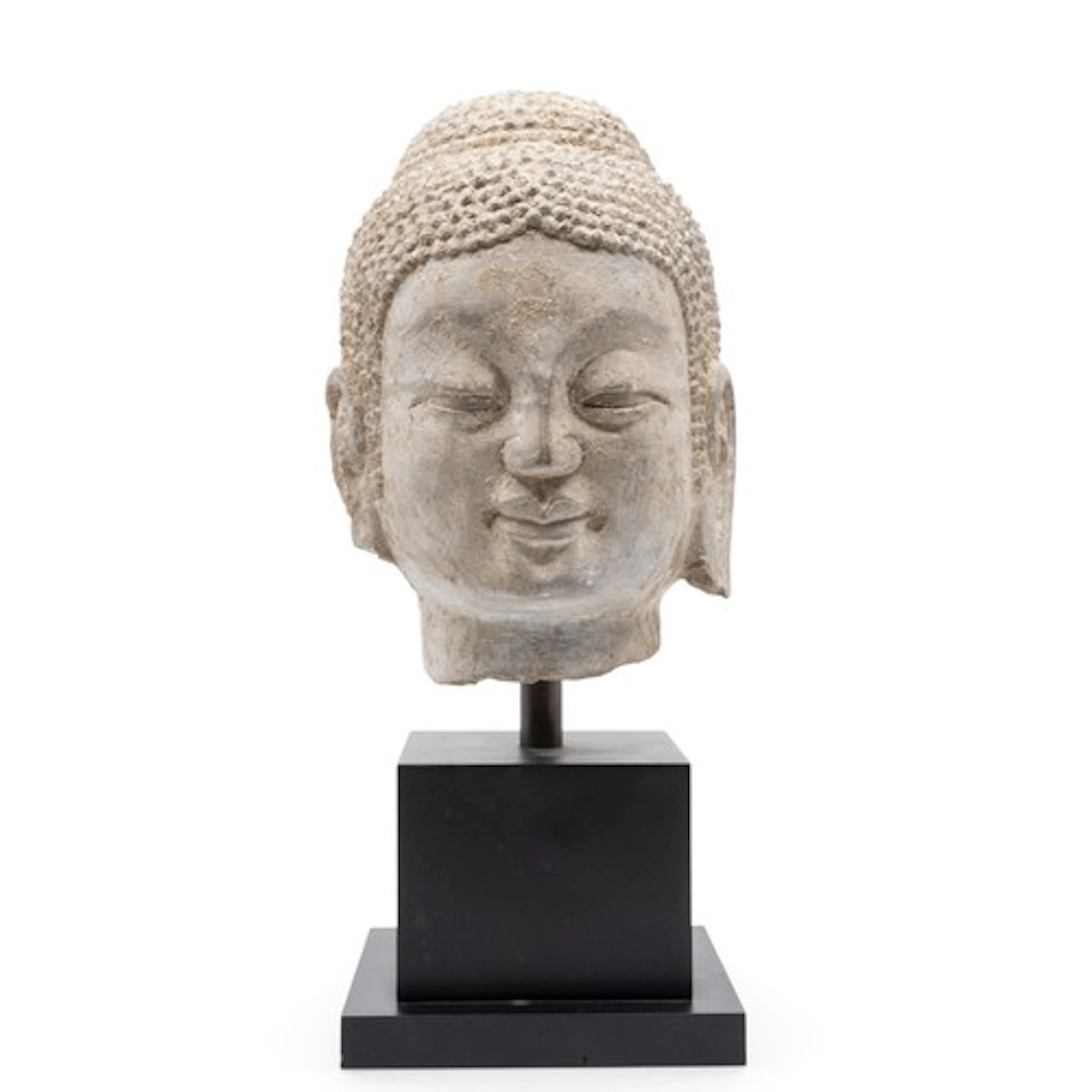 A LIMESTONE BUDDHA HEAD MING DYNASTY OR EARLIER raised on a...
