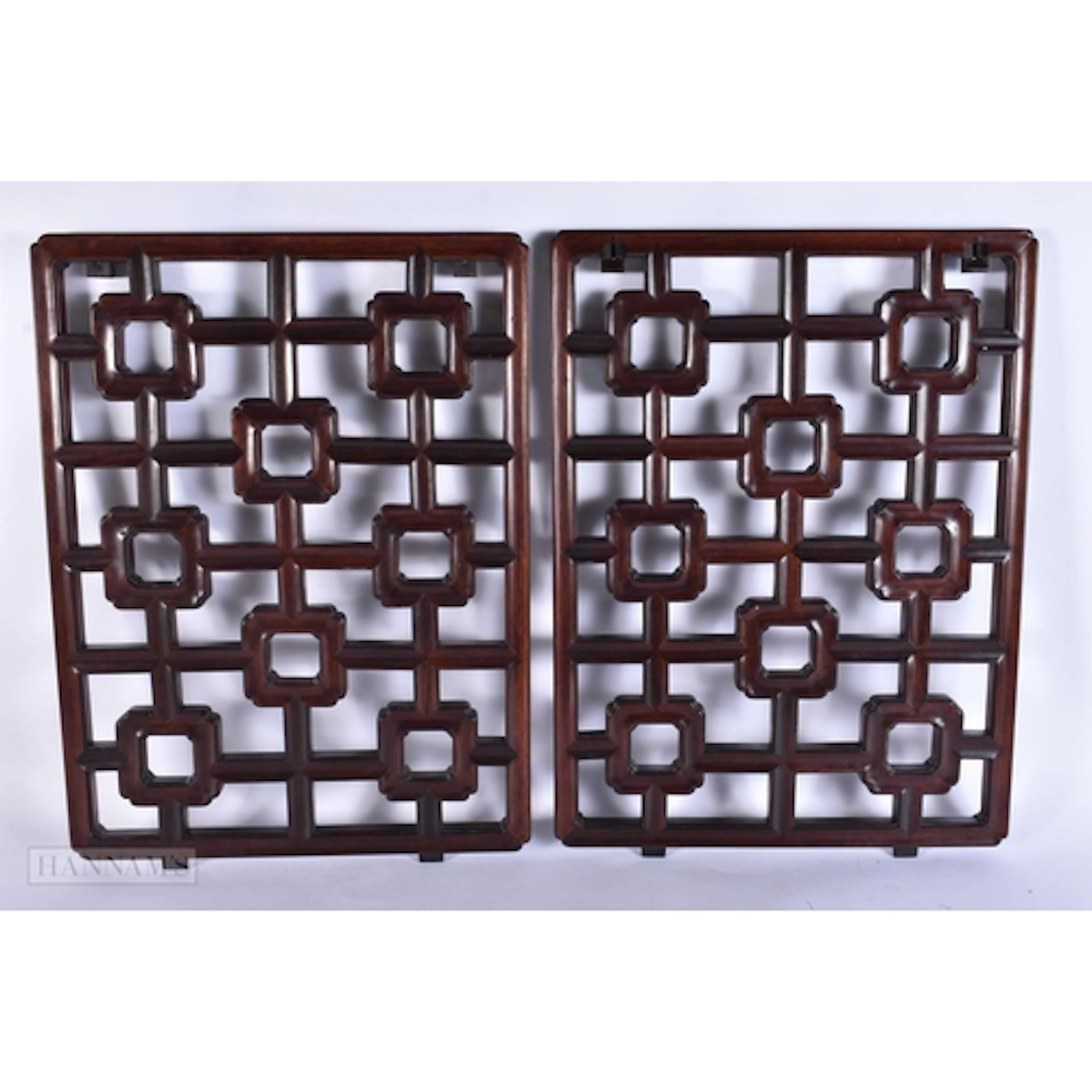 A PAIR OF CHINESE QING DYNASTY CARVED HUANGHUALI WOOD PANELS...
