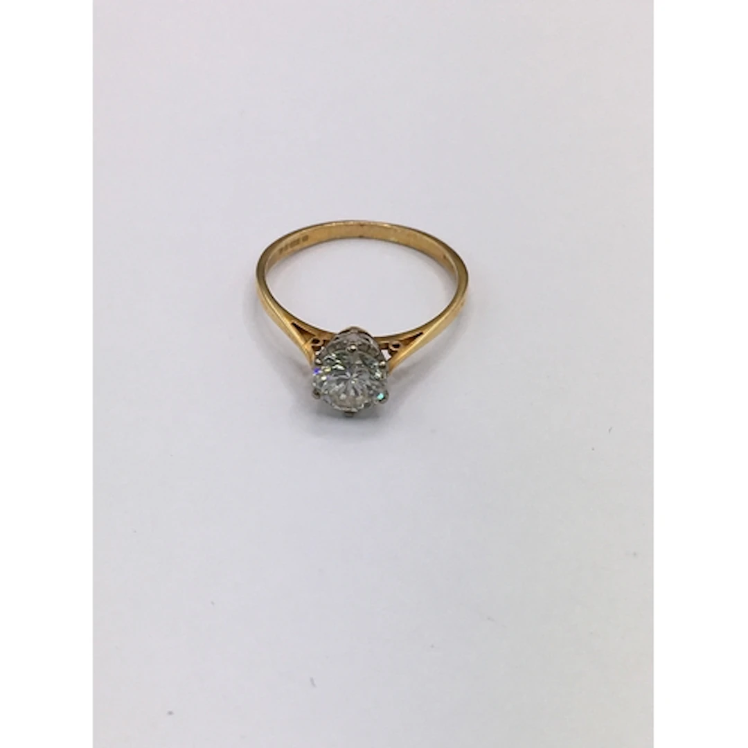 An 18ct gold diamond solitaire ring. Size M