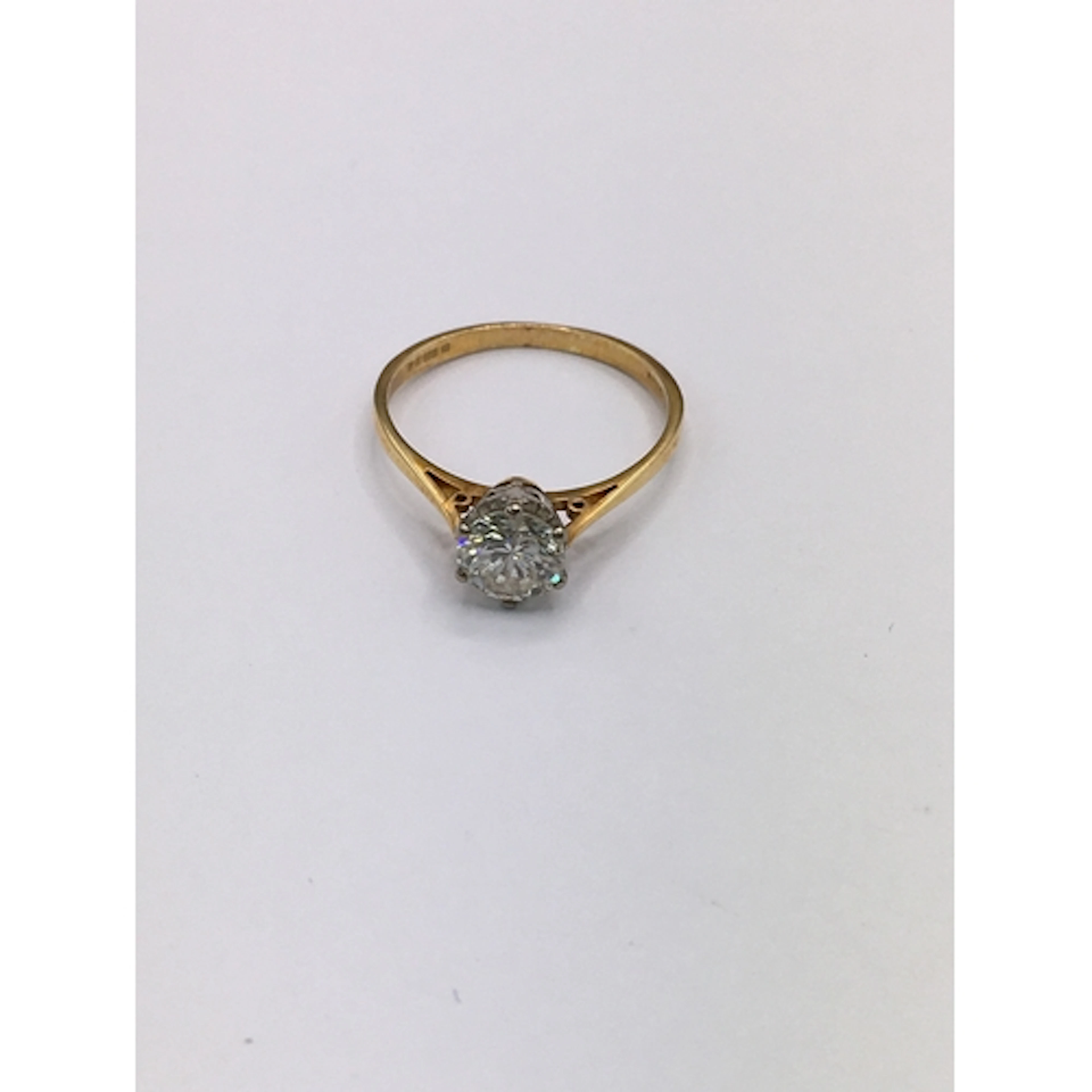 An 18ct gold diamond solitaire ring. Size M