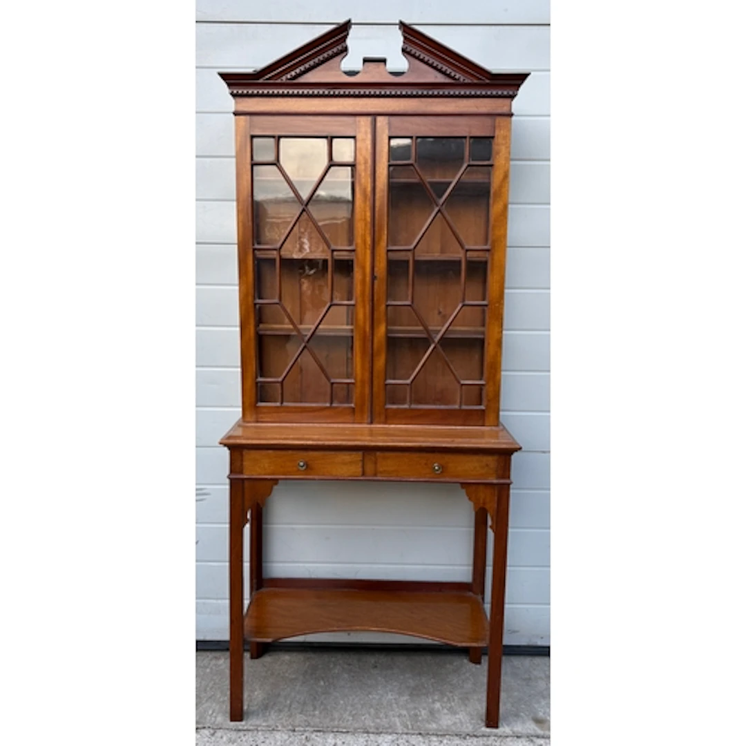 An Edwardian Sheraton-style mahogany china cabinet on a stan...