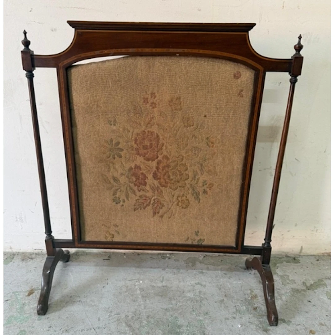 A mahogany framed fire screen with central floral tapestry. ...