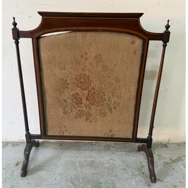A mahogany framed fire screen with central floral tapestry. ...