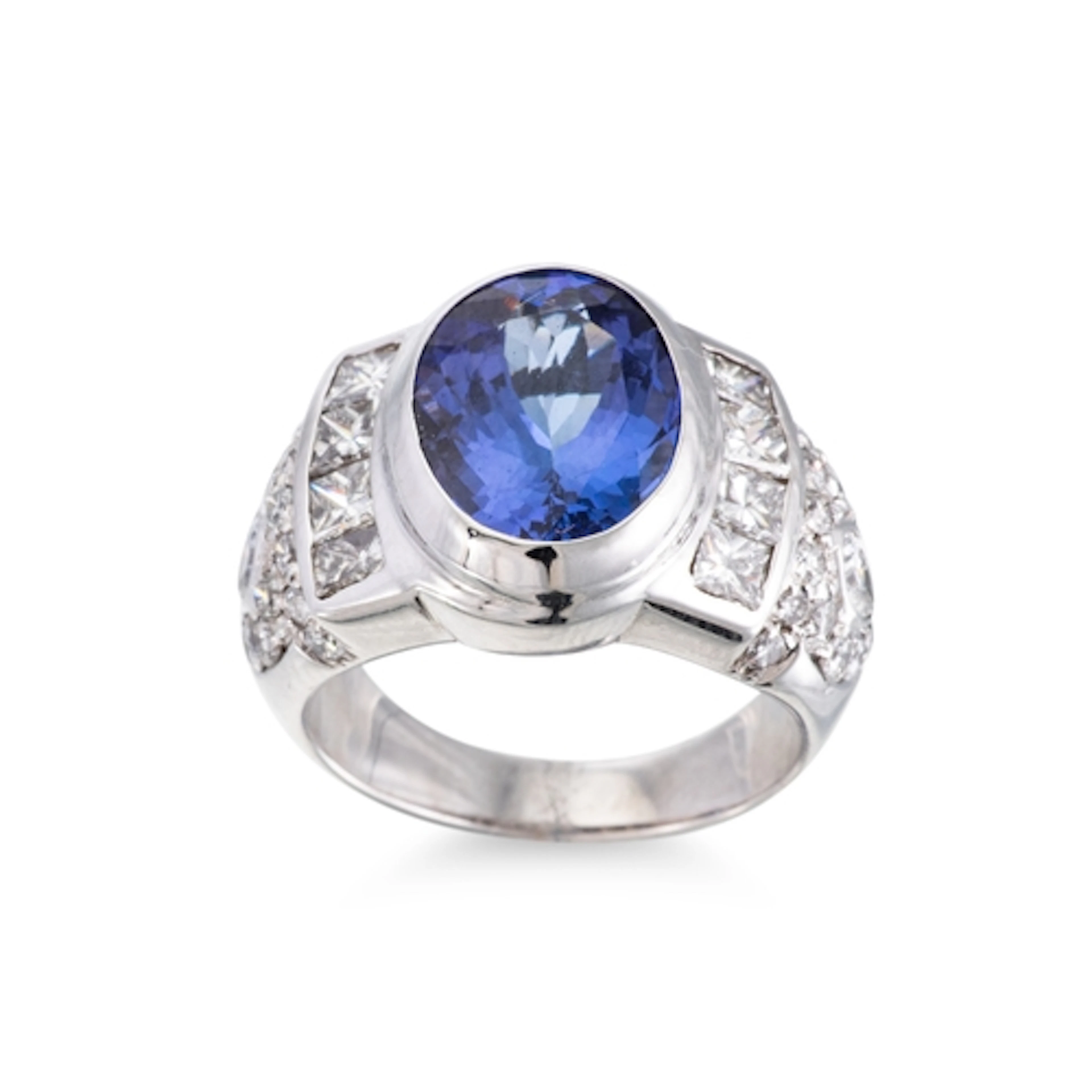 A TANZANITE AND DIAMOND RING, the oval tanzanite to diamond ...