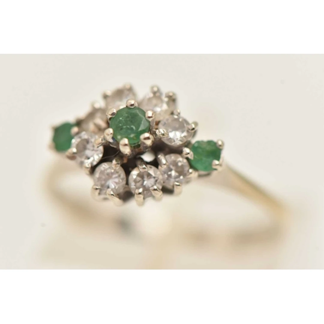 AN 18CT WHITE GOLD GEM SET CLUSTER RING, three circular cut ...