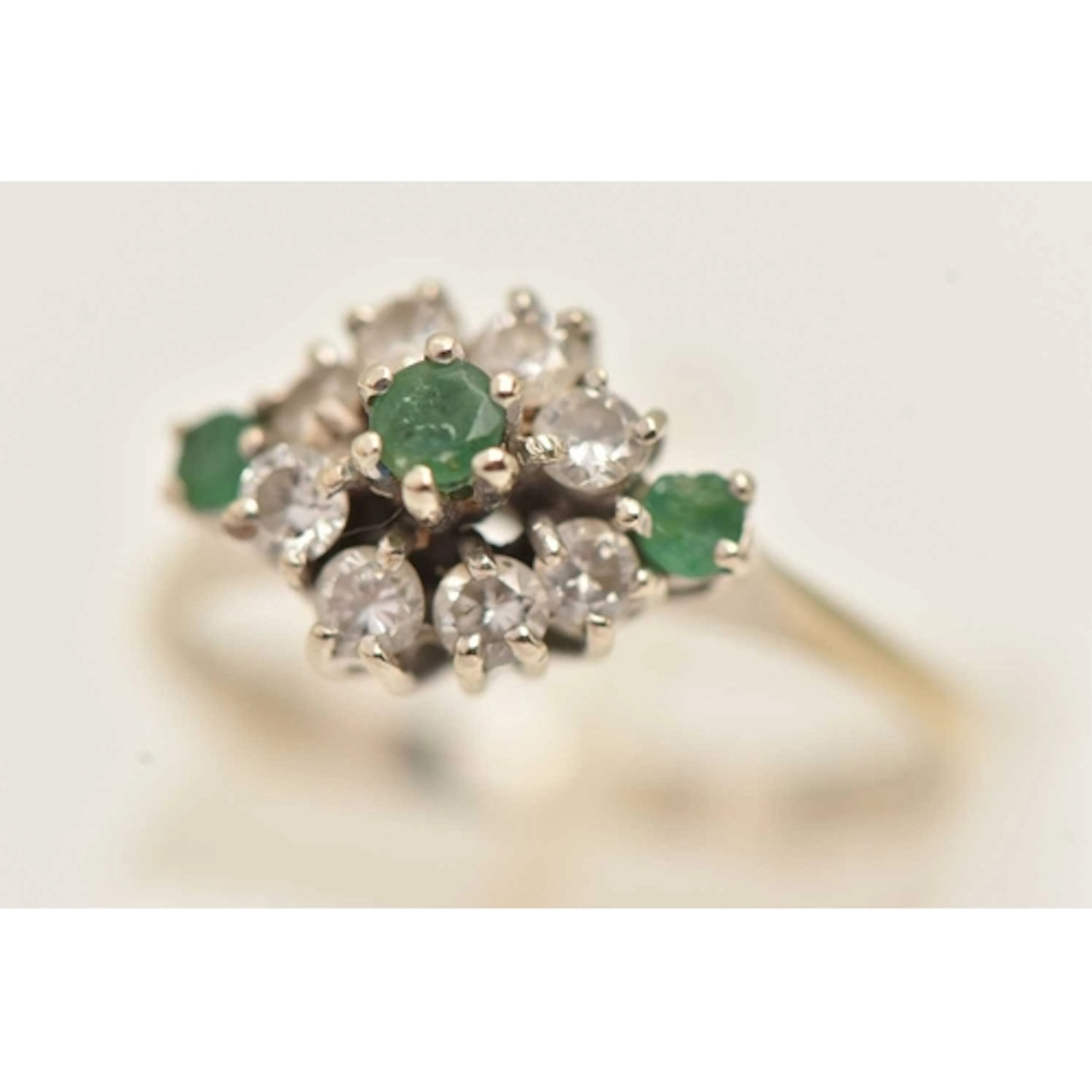 AN 18CT WHITE GOLD GEM SET CLUSTER RING, three circular cut ...