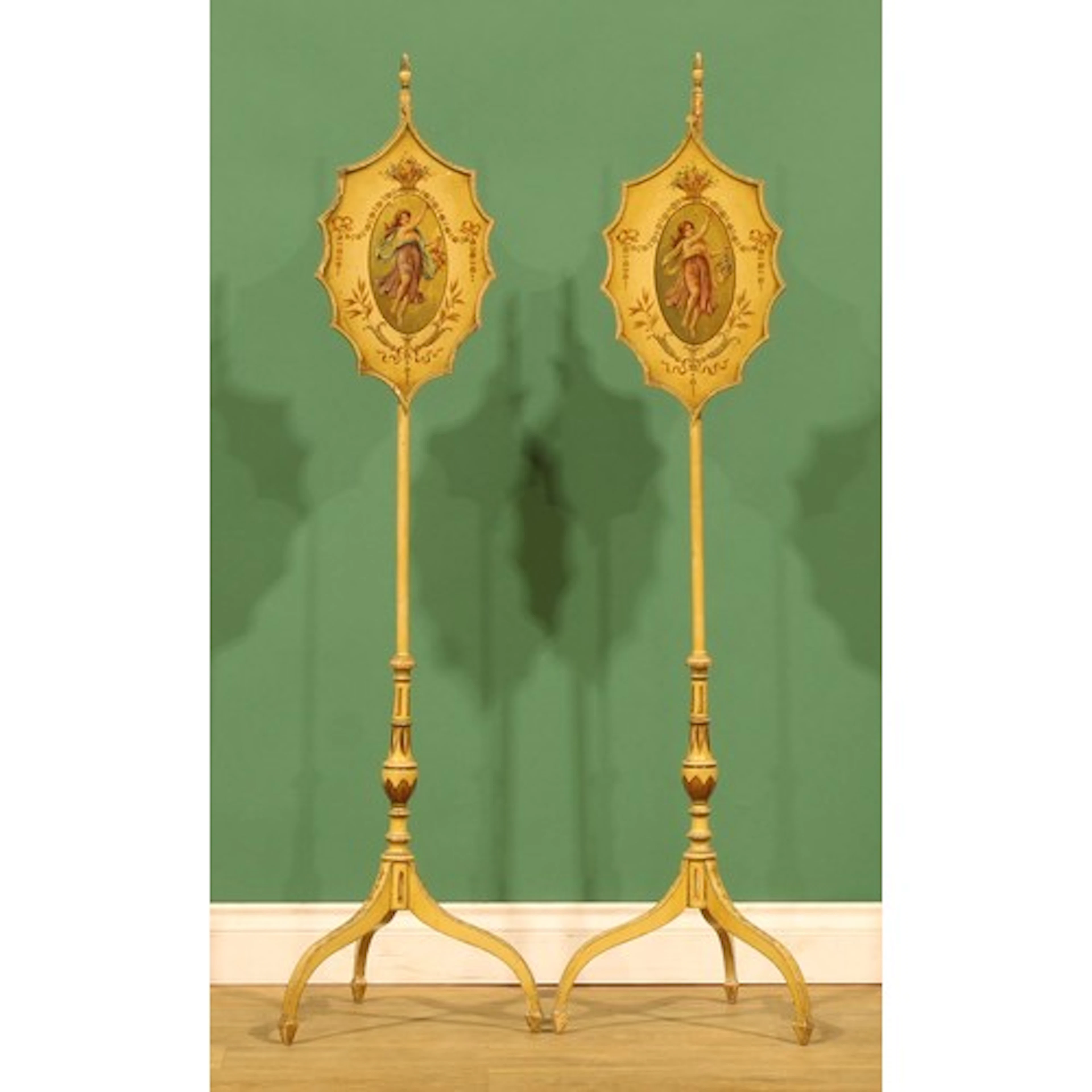 A pair of Sheraton Revival painted pole screens, each banner...
