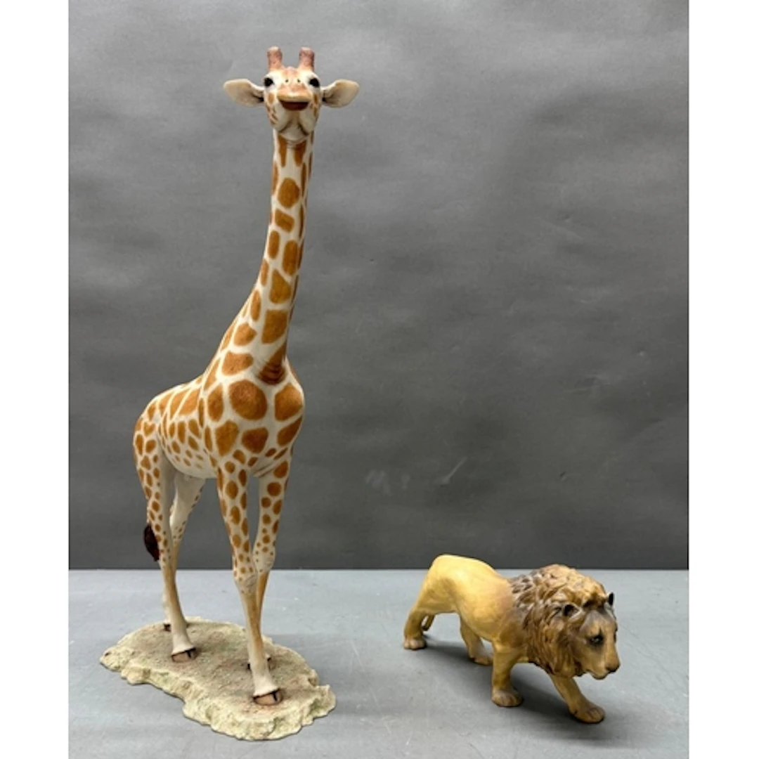 A Coalport figure of a lion together with a plaster figure o...