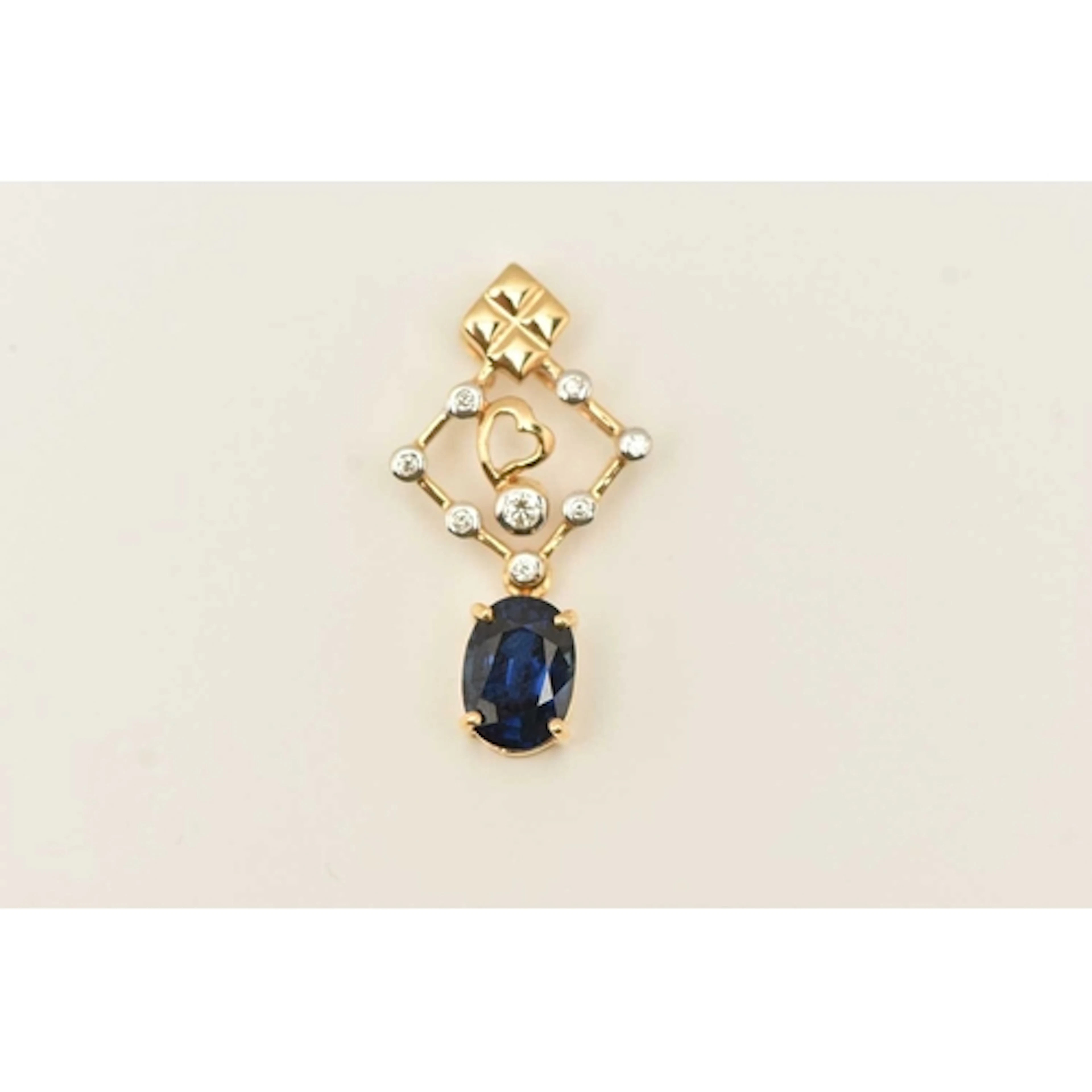 A 9CT YELLOW GOLD GEM SET PENDANT, an open work pendant set ...