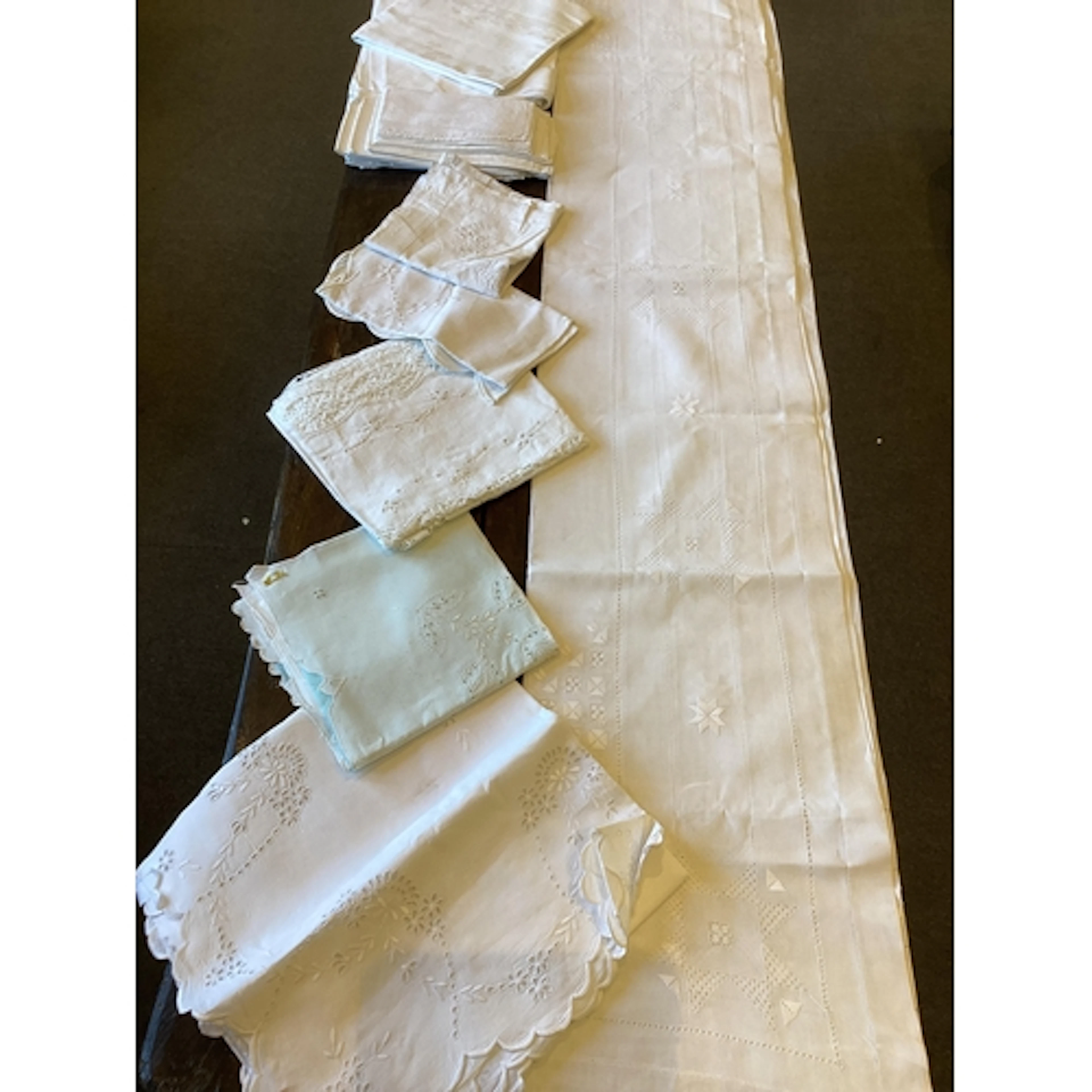 A collection of table linen cloths, including damask, variou...
