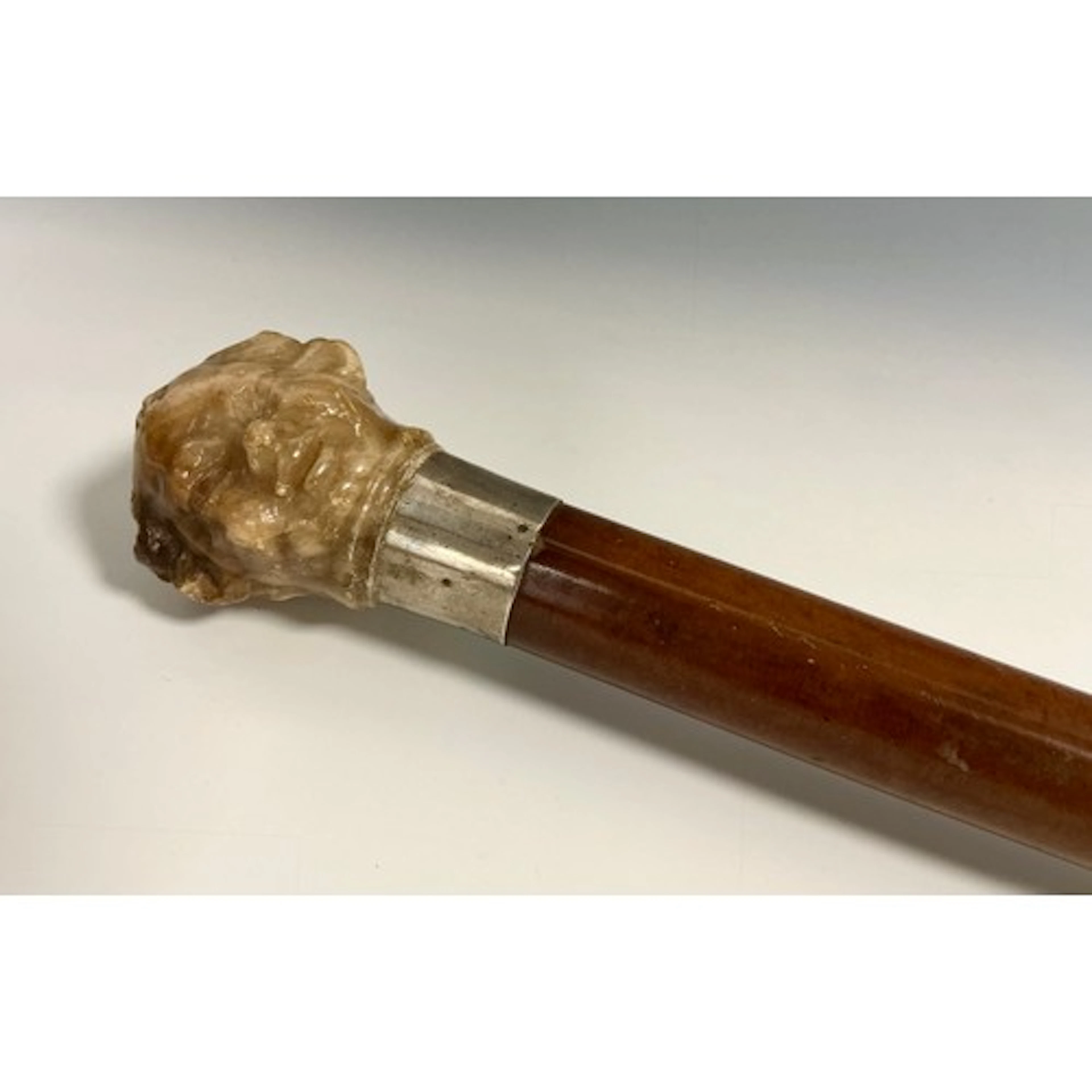 A 19th century antiquarian's walking cane, the pommel a 17th...