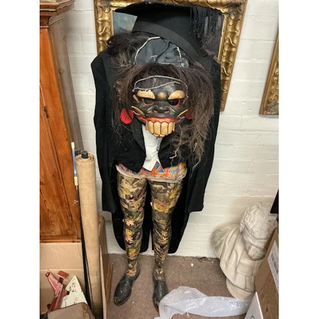 A figure sculpture 20th century with a grotesque mask.