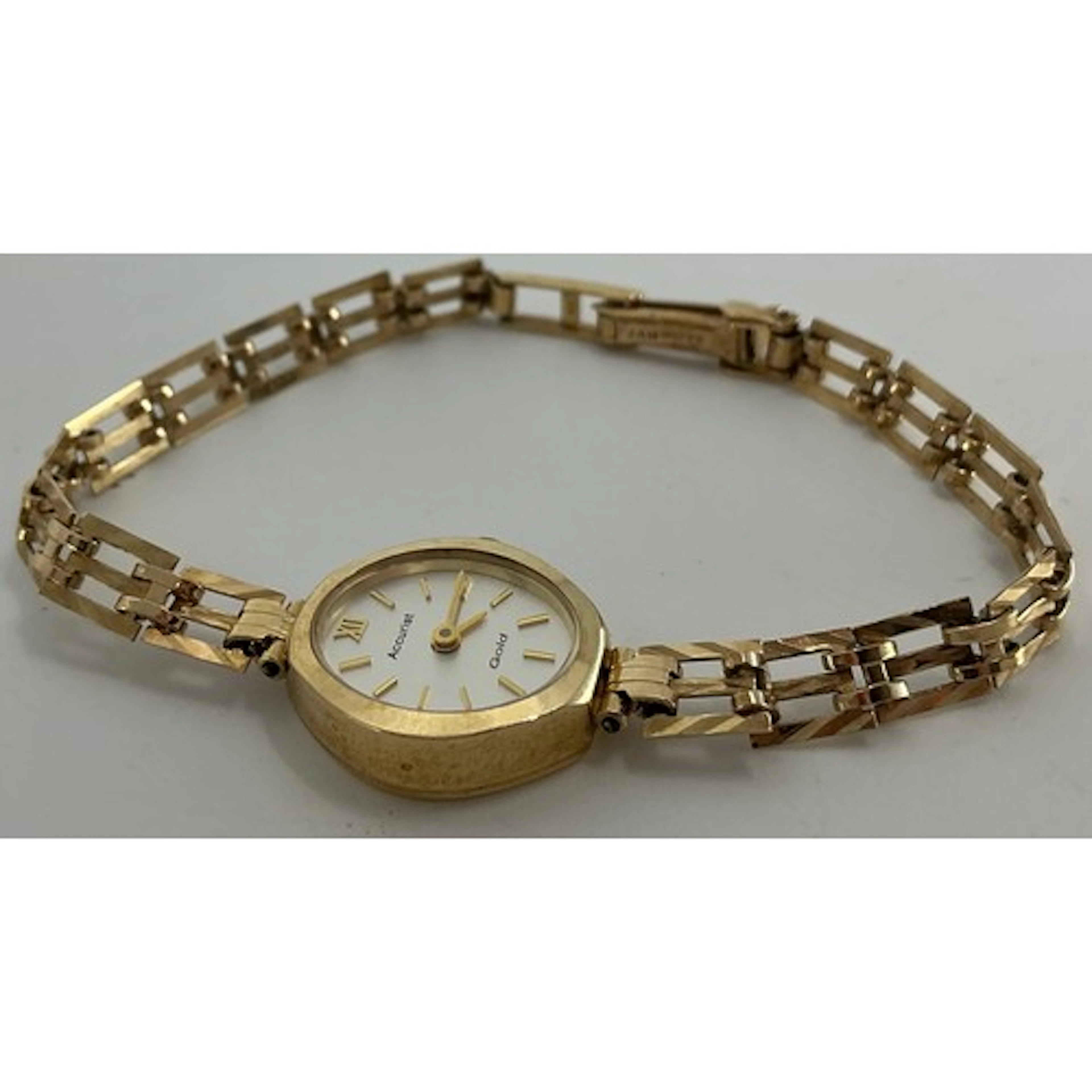 A lady's Accurist 9ct gold cased bracelet watch, oval silver...
