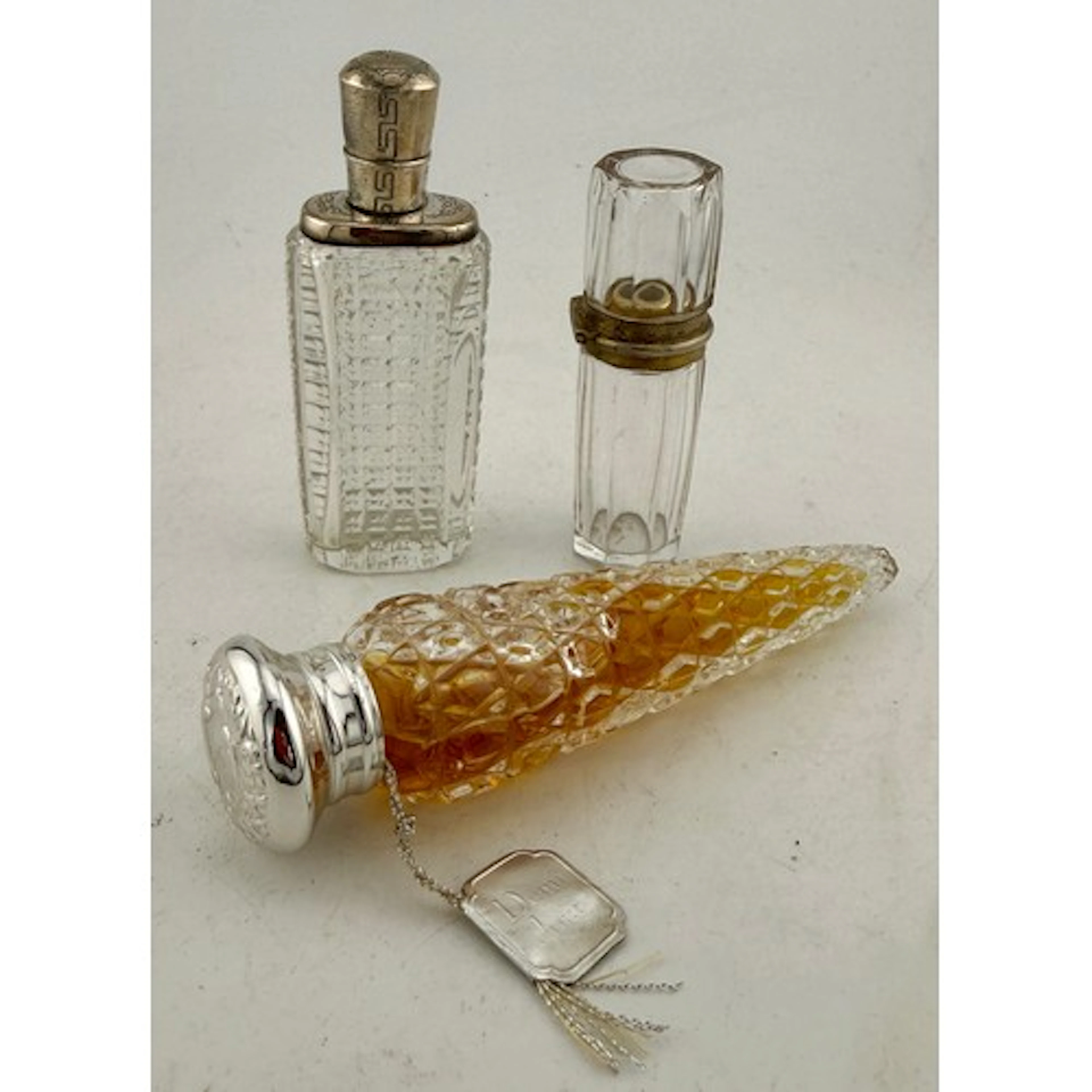 Three white metal mounted glass scent bottle to include Demi...