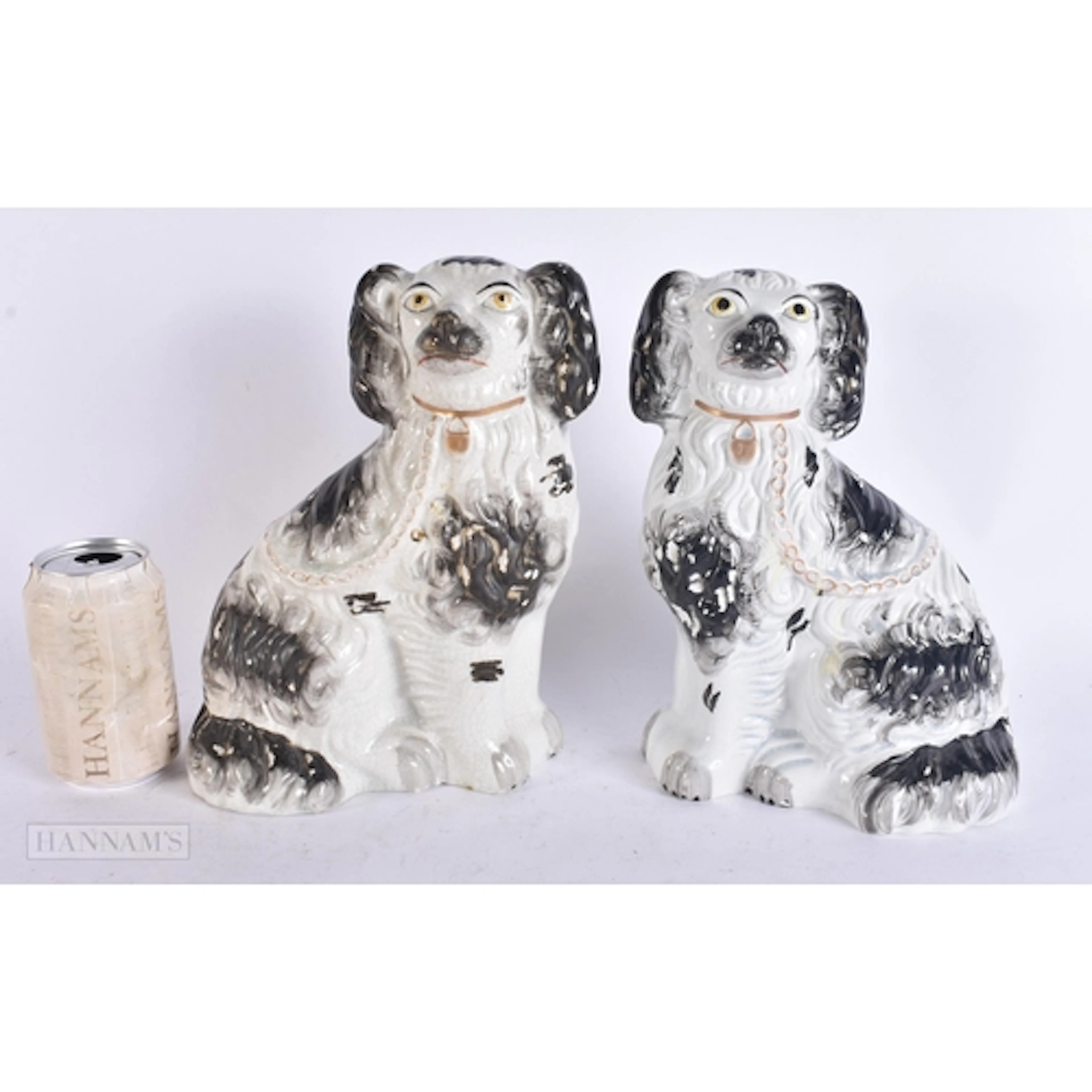 A PAIR OF VICTORIAN BLACK AND WHITE STAFFORDSHIRE DOGS. 27 c...