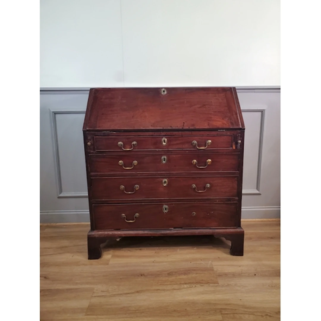 An antique mahogany Bureau, the fall front enclosing pigeon ...