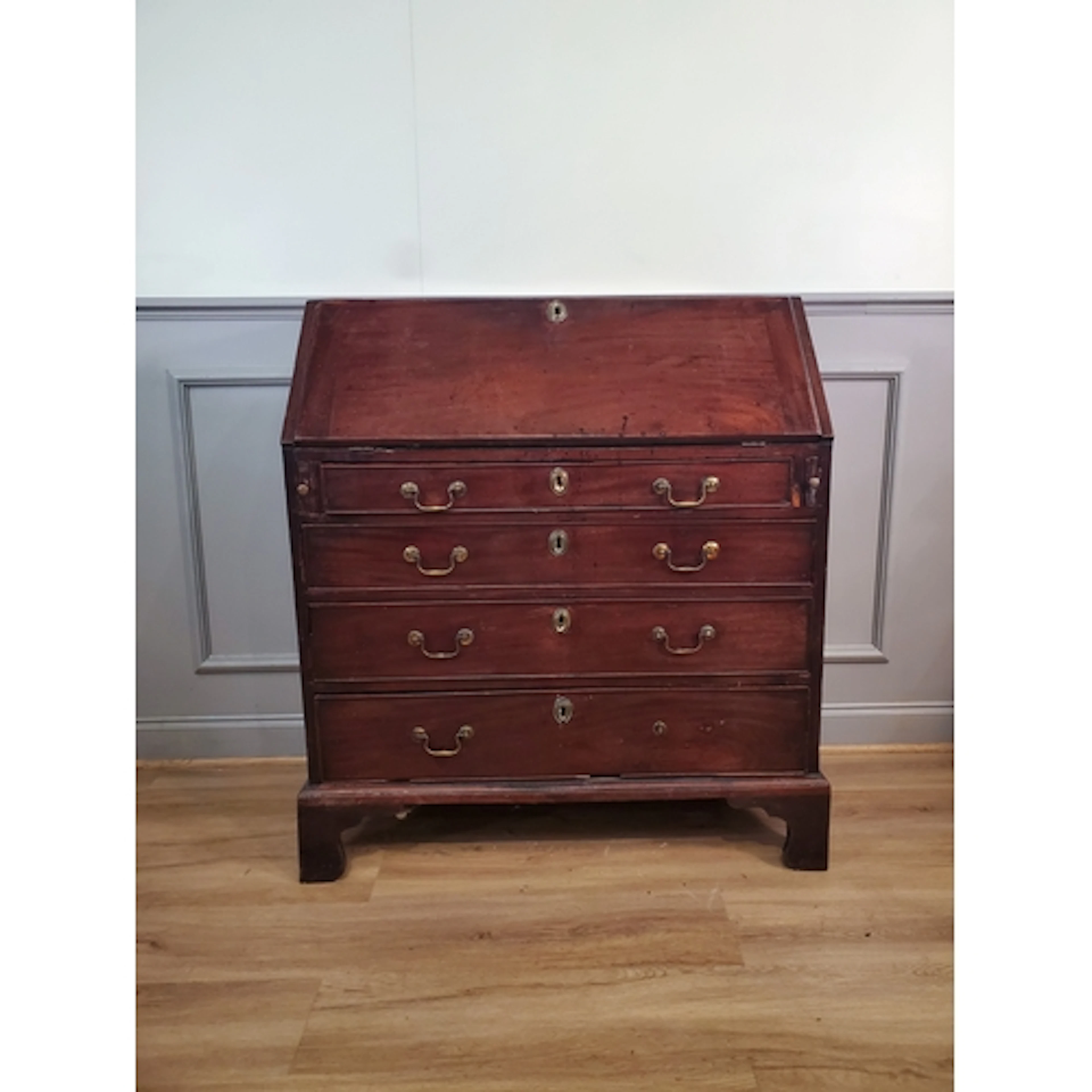 An antique mahogany Bureau, the fall front enclosing pigeon ...