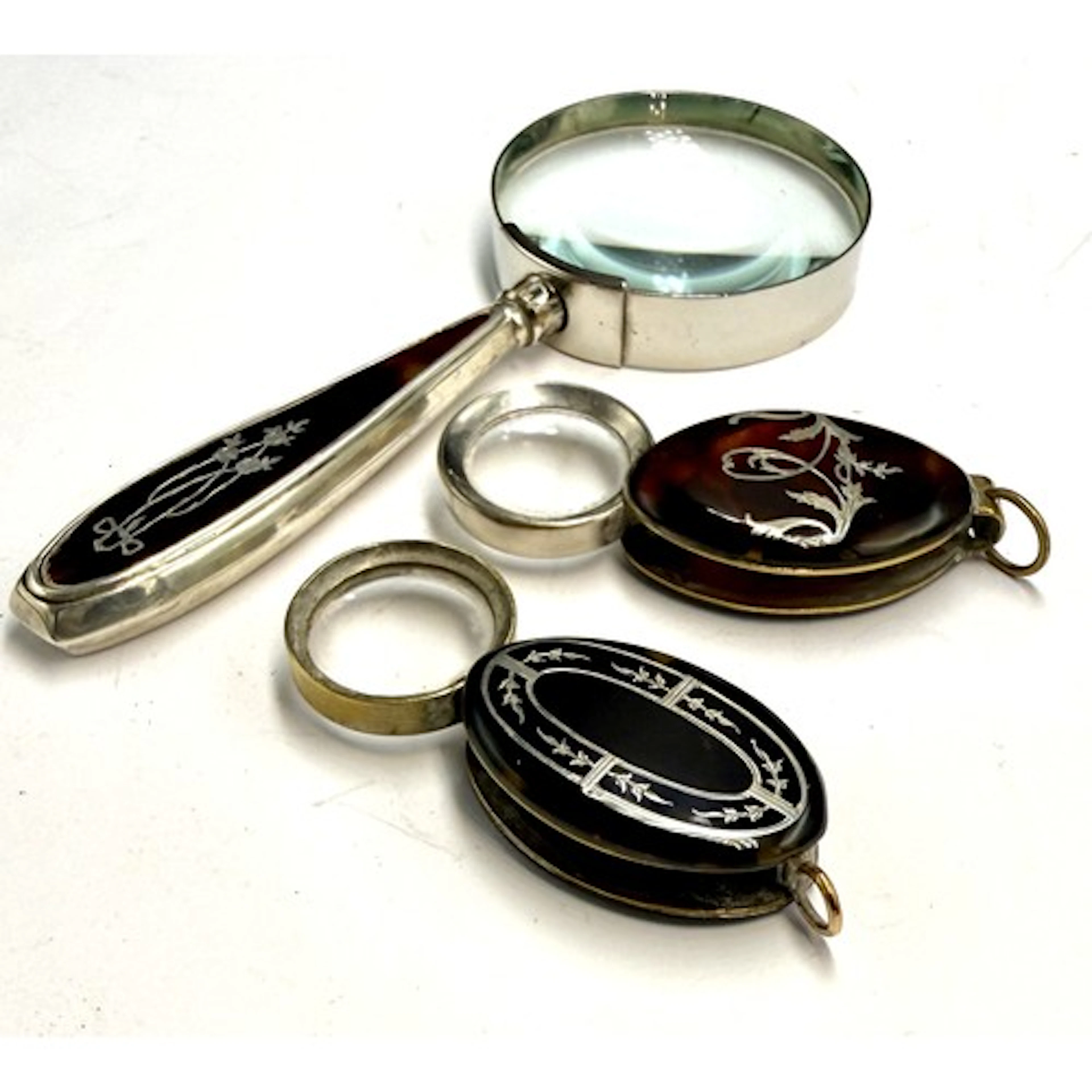 Two tortoiseshell pique cased eye glasses together with a si...