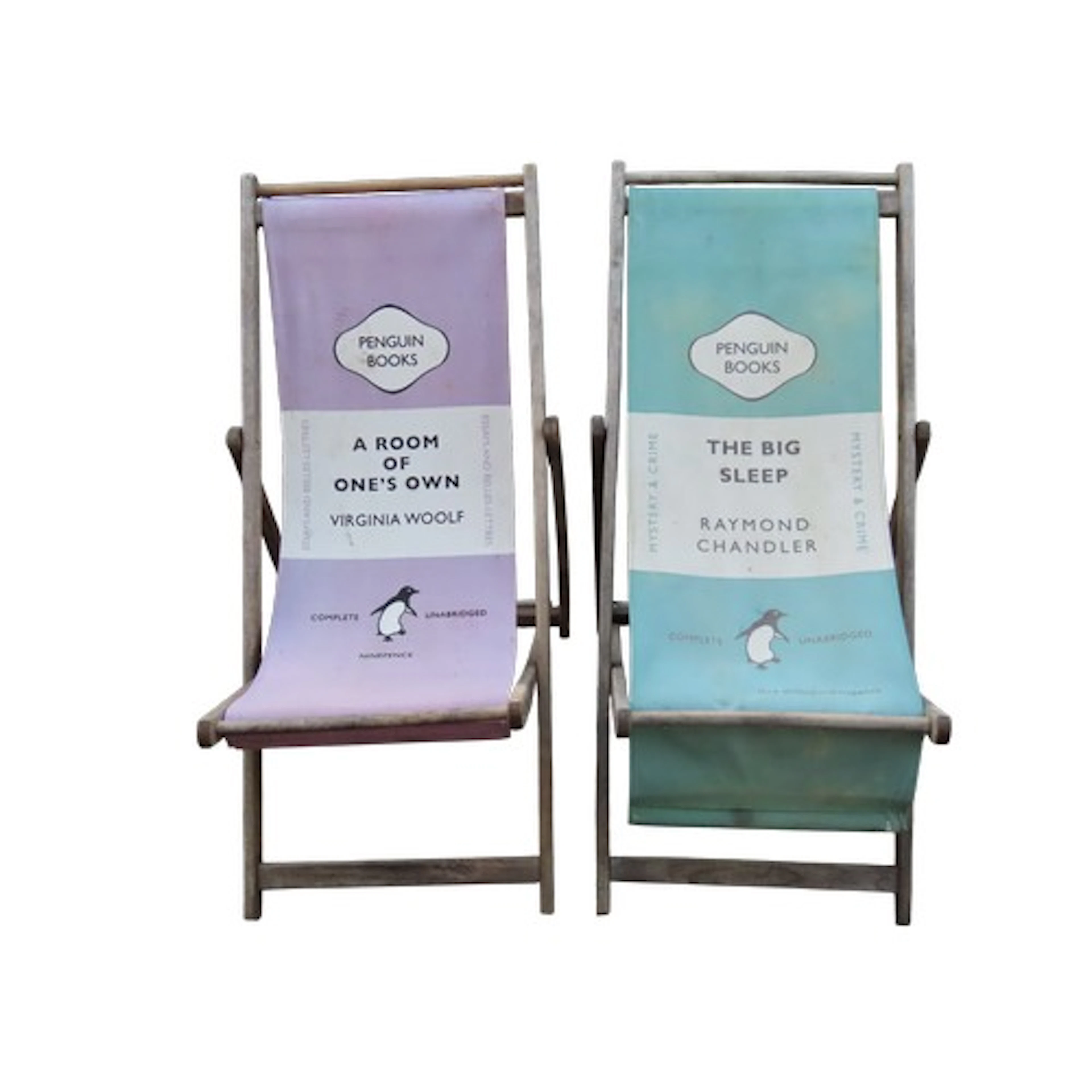 Two weathered traditional folding deck chairs with decorativ...