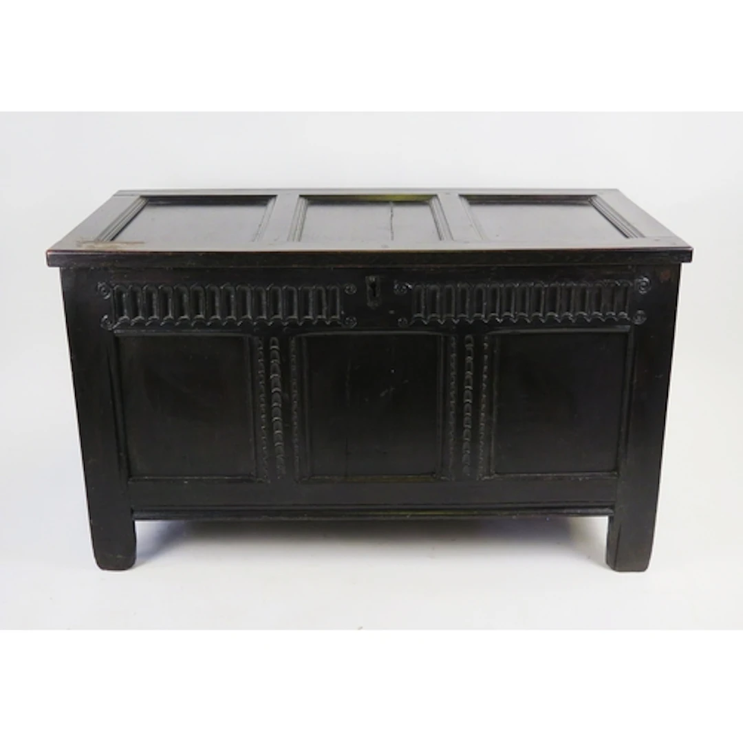 An oak coffer of rectangular form with triple panel hinged l...