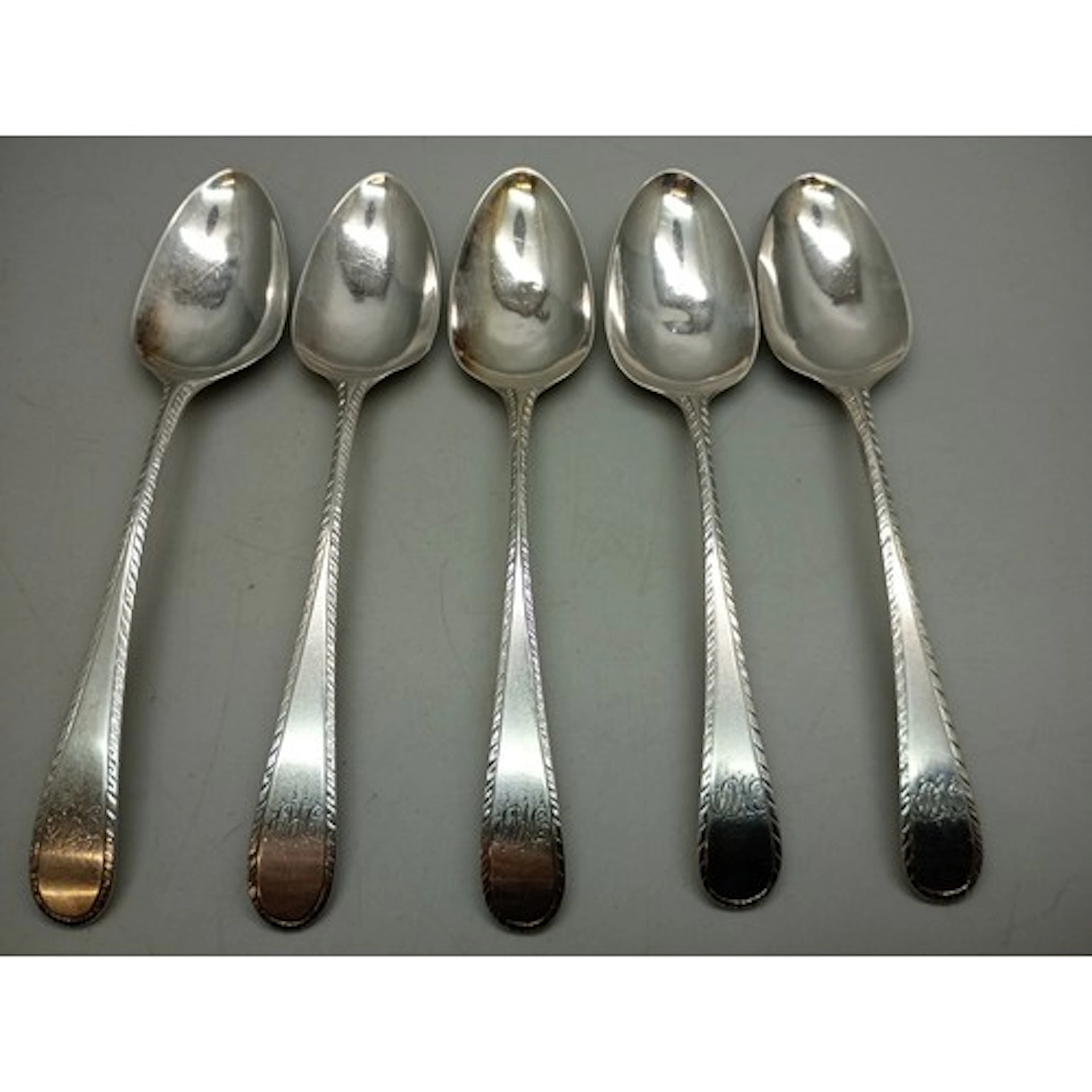 A set of George III silver spoons with monograms, London, 18...