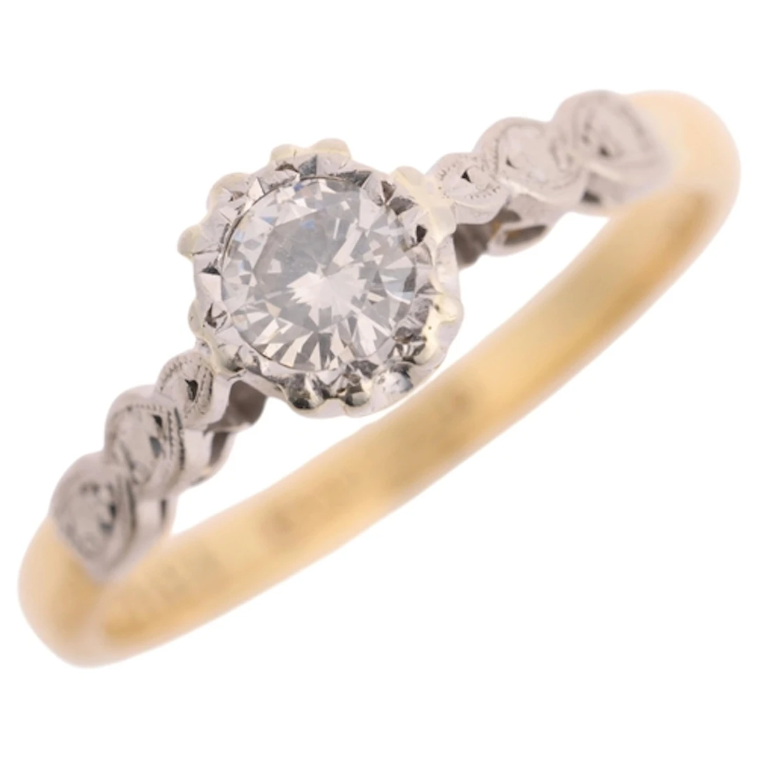 An 18ct gold 0.05ct single stone diamond ring, platinum-topp...