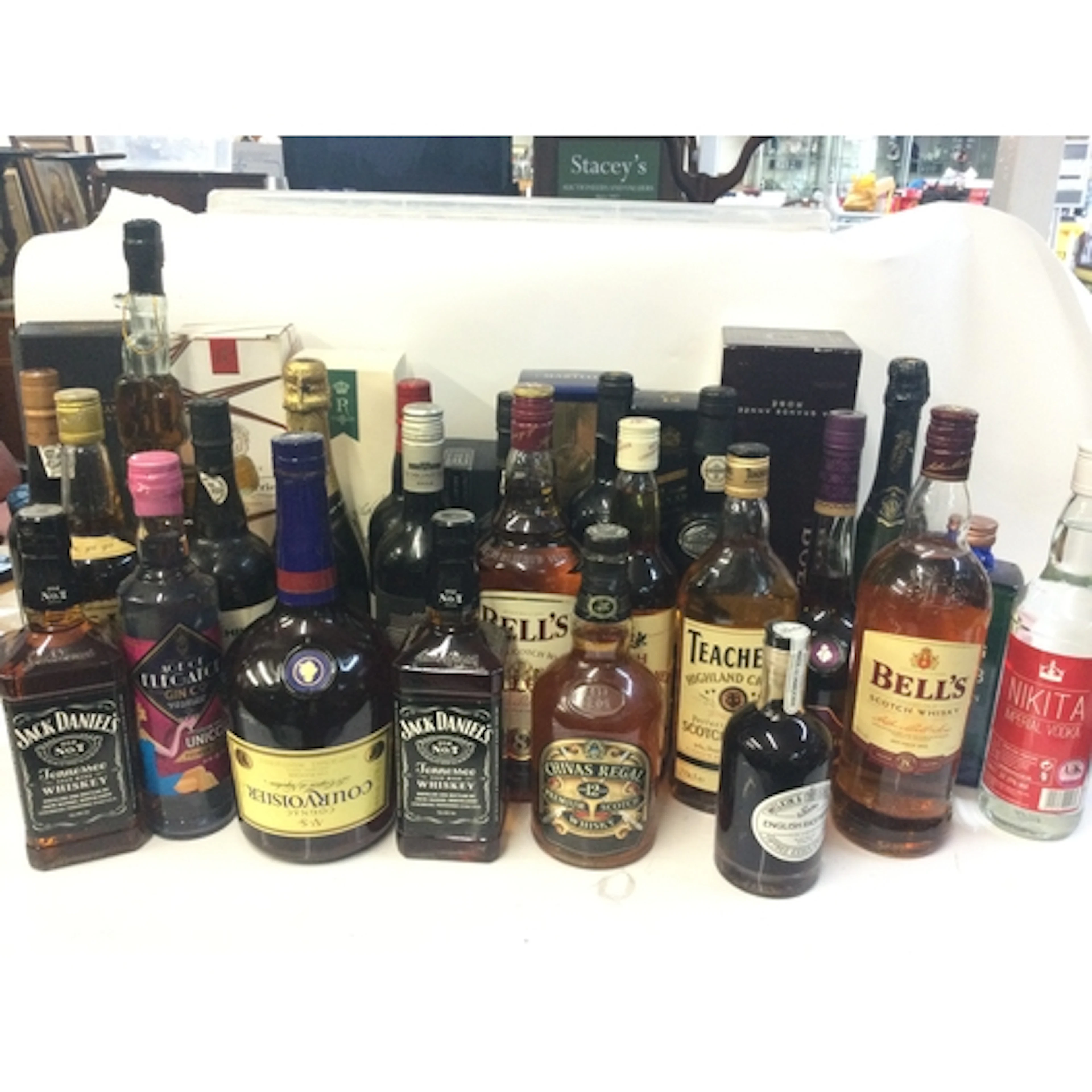 A collection of spirits and whiskeys including jack Daniels,...