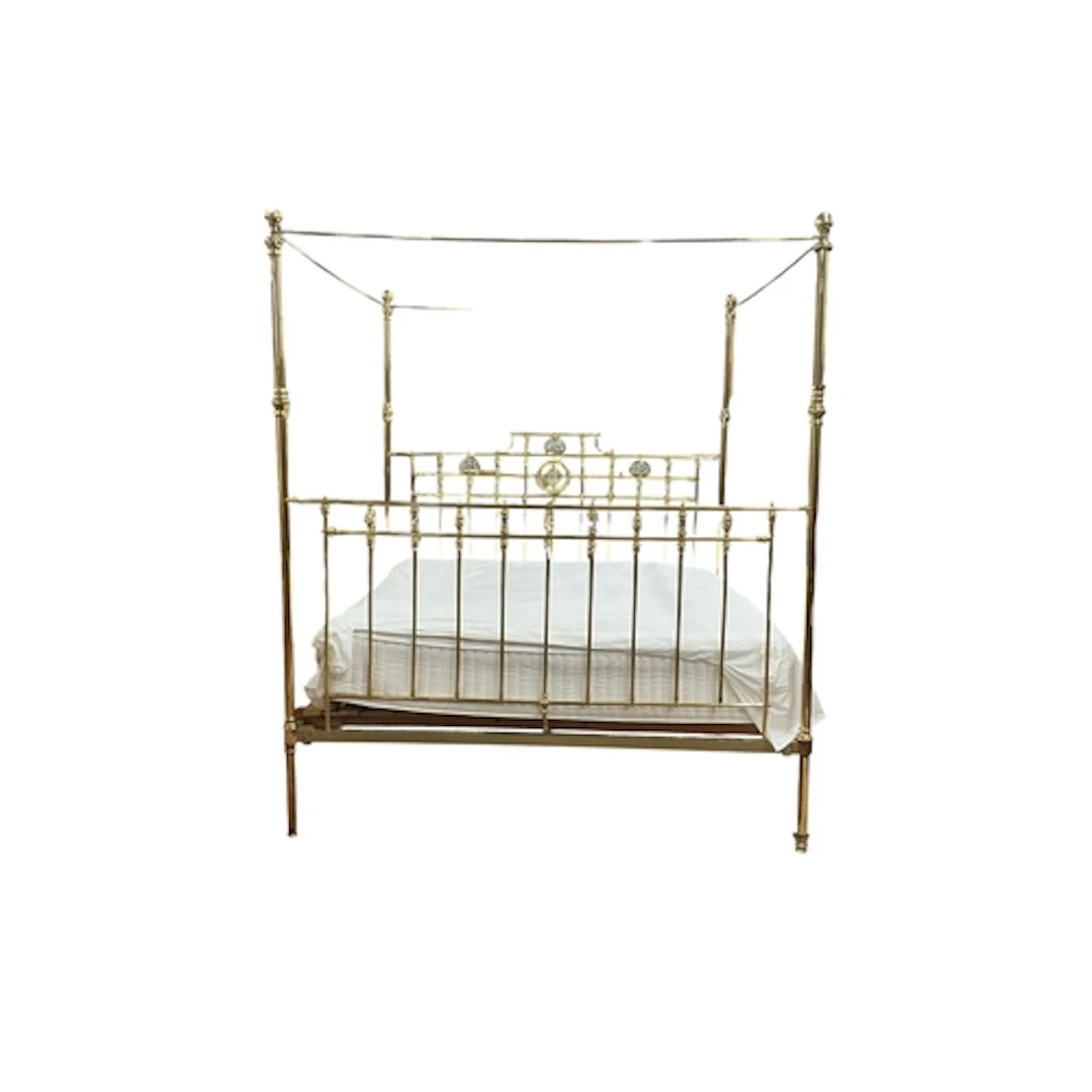 An Edwardian brass four poster bed with mother of pearl deco...