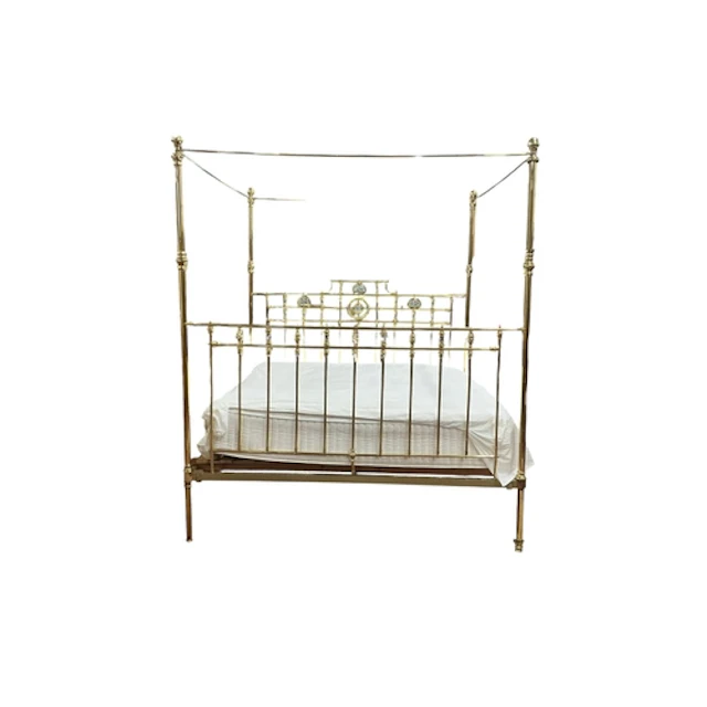 An Edwardian brass four poster bed with mother of pearl deco...
