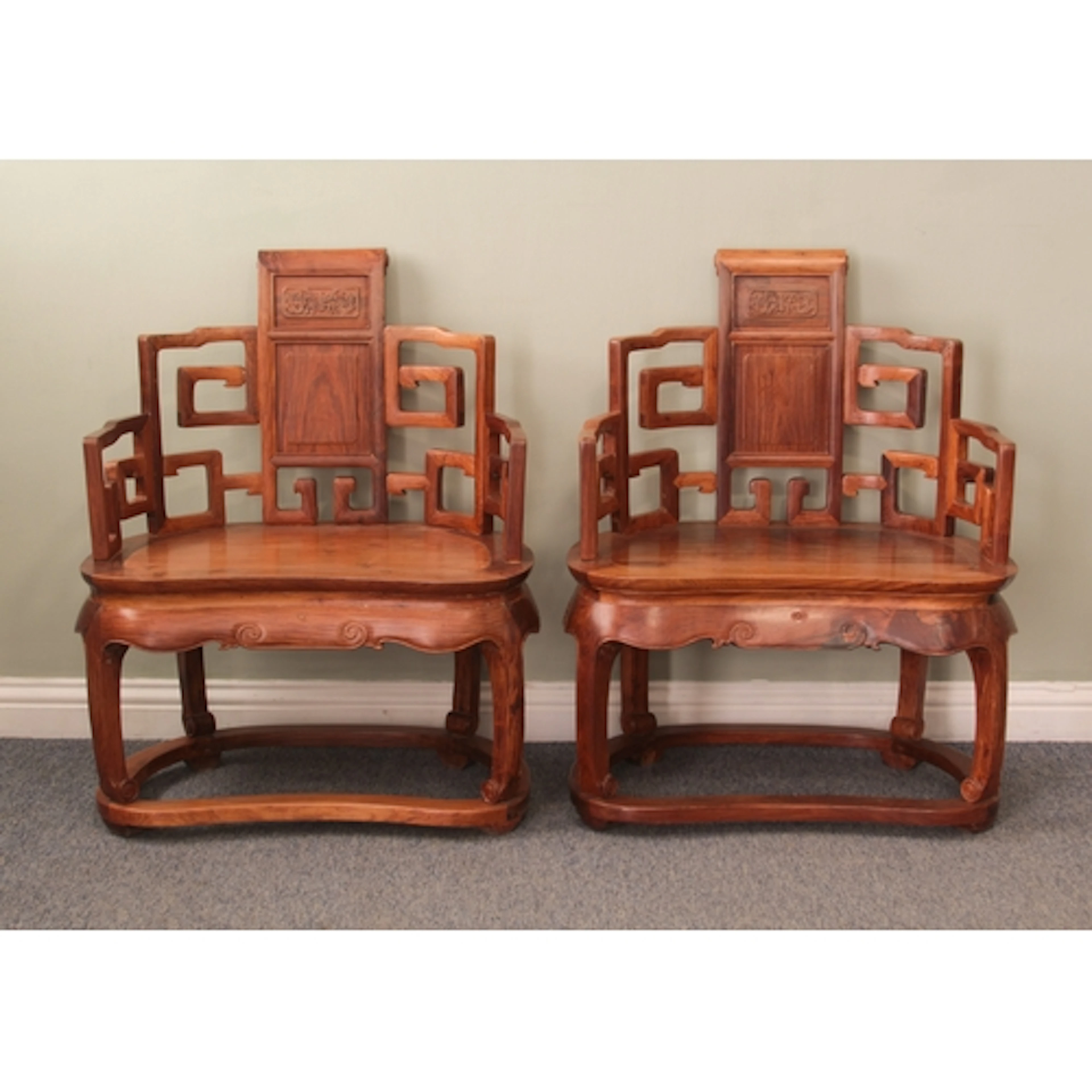 A pair of Chinese carved hardwood open armchairs - late 20th...