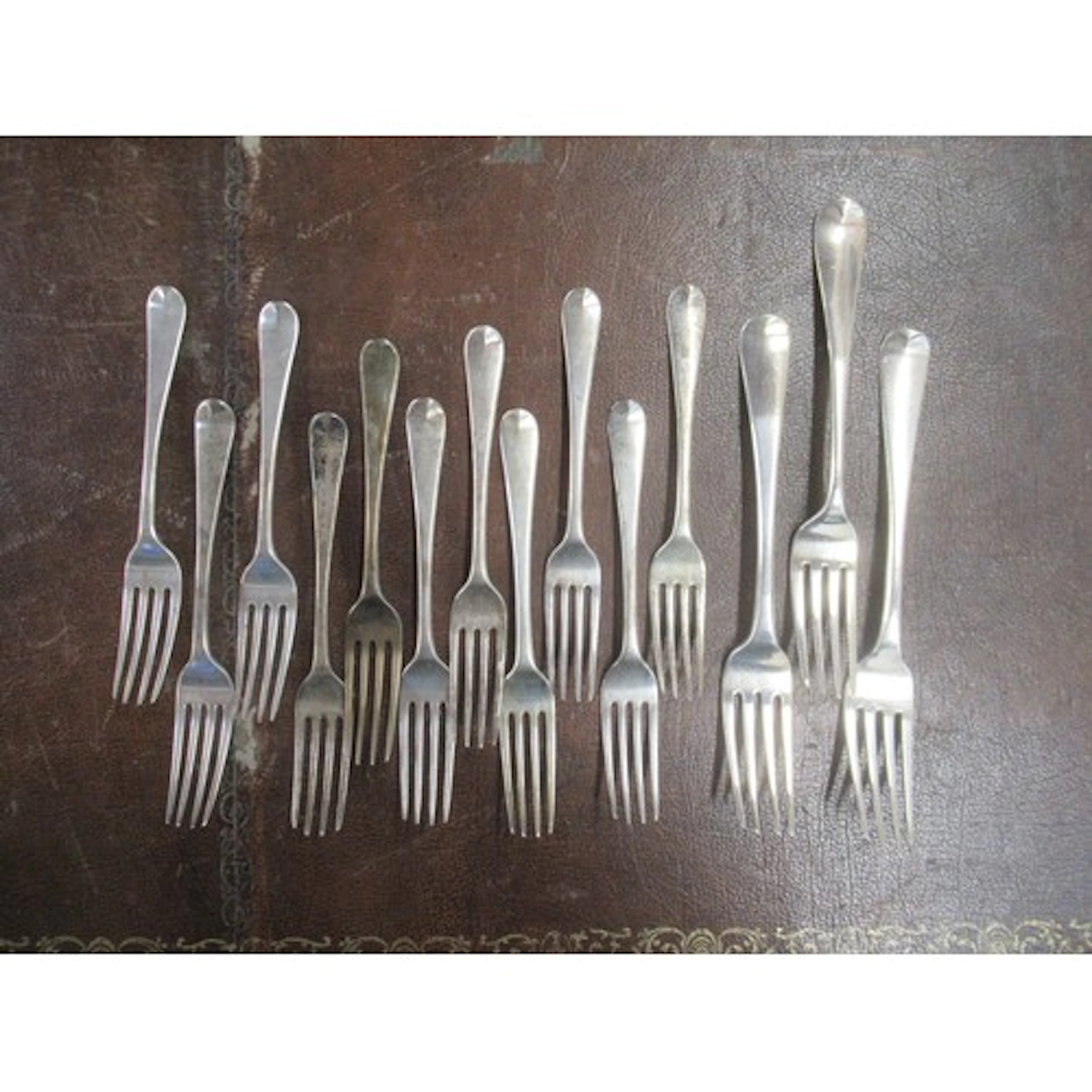 A set of 11 Georgian silver dessert forks, together with 3 s...